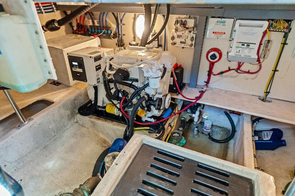 Engine room of 2005 Luhrs 38 Convertible boat, showcasing machinery and wiring.