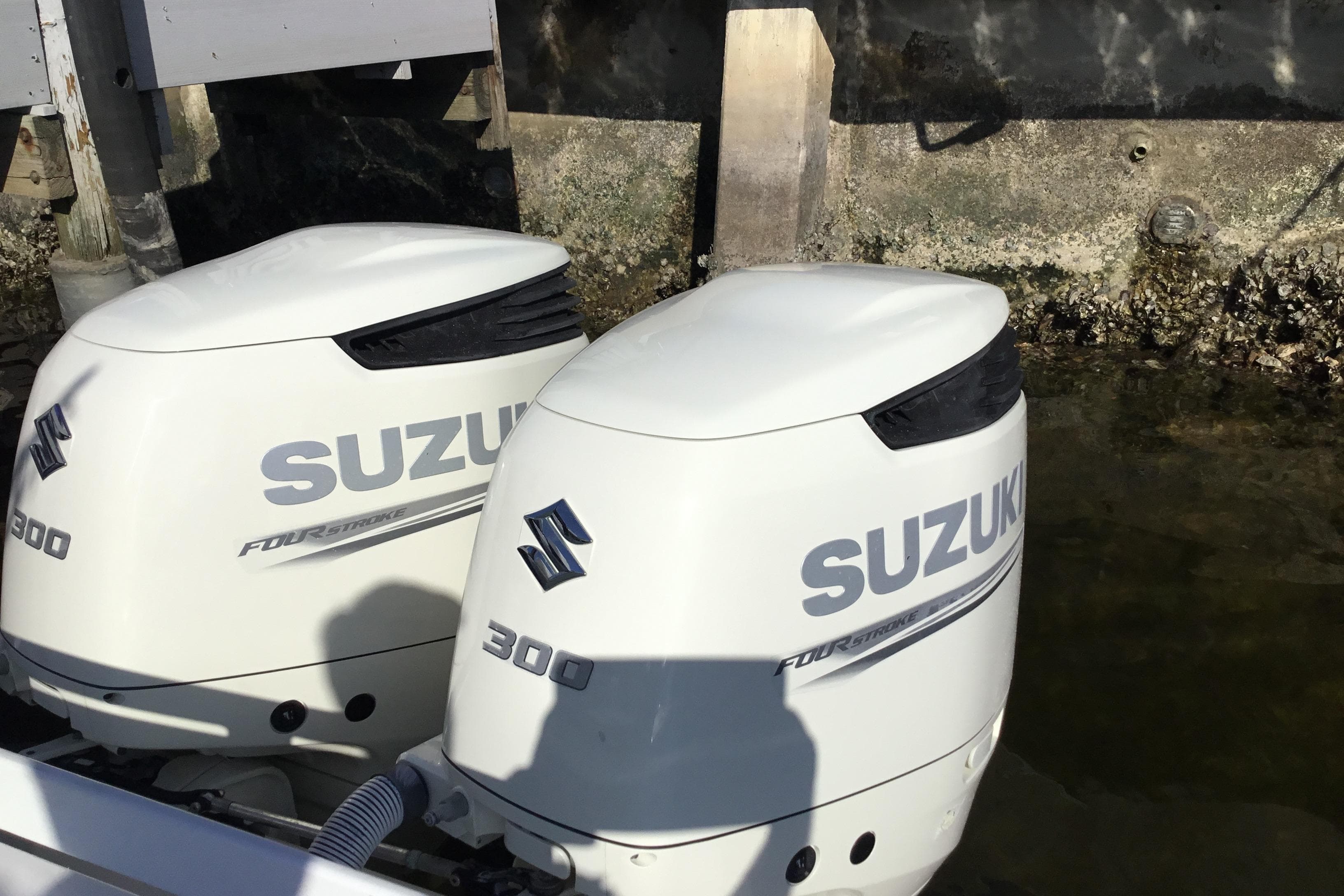 Twin Suzuki 300 outboard engines on a 2000 Jupiter 31 Center Console boat.