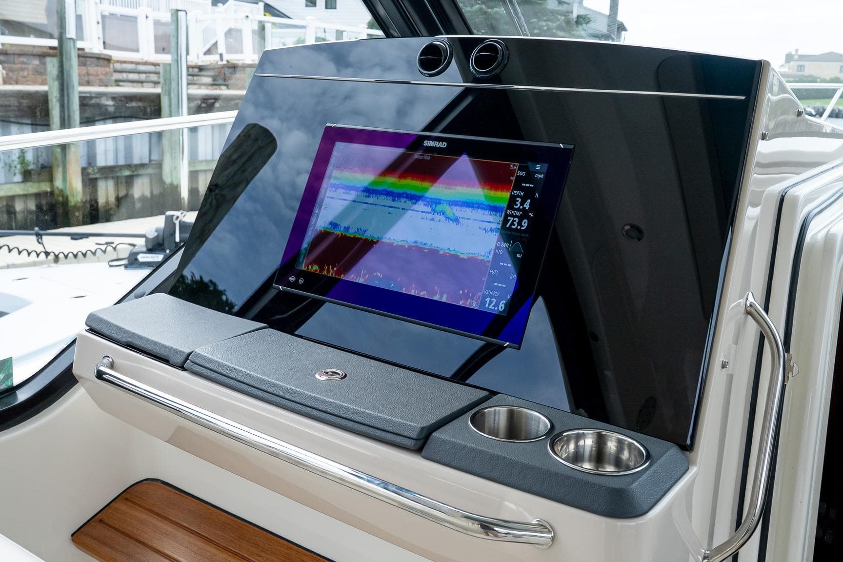 2024 Boston Whaler 405 Conquest dashboard with Simrad display and cup holders.