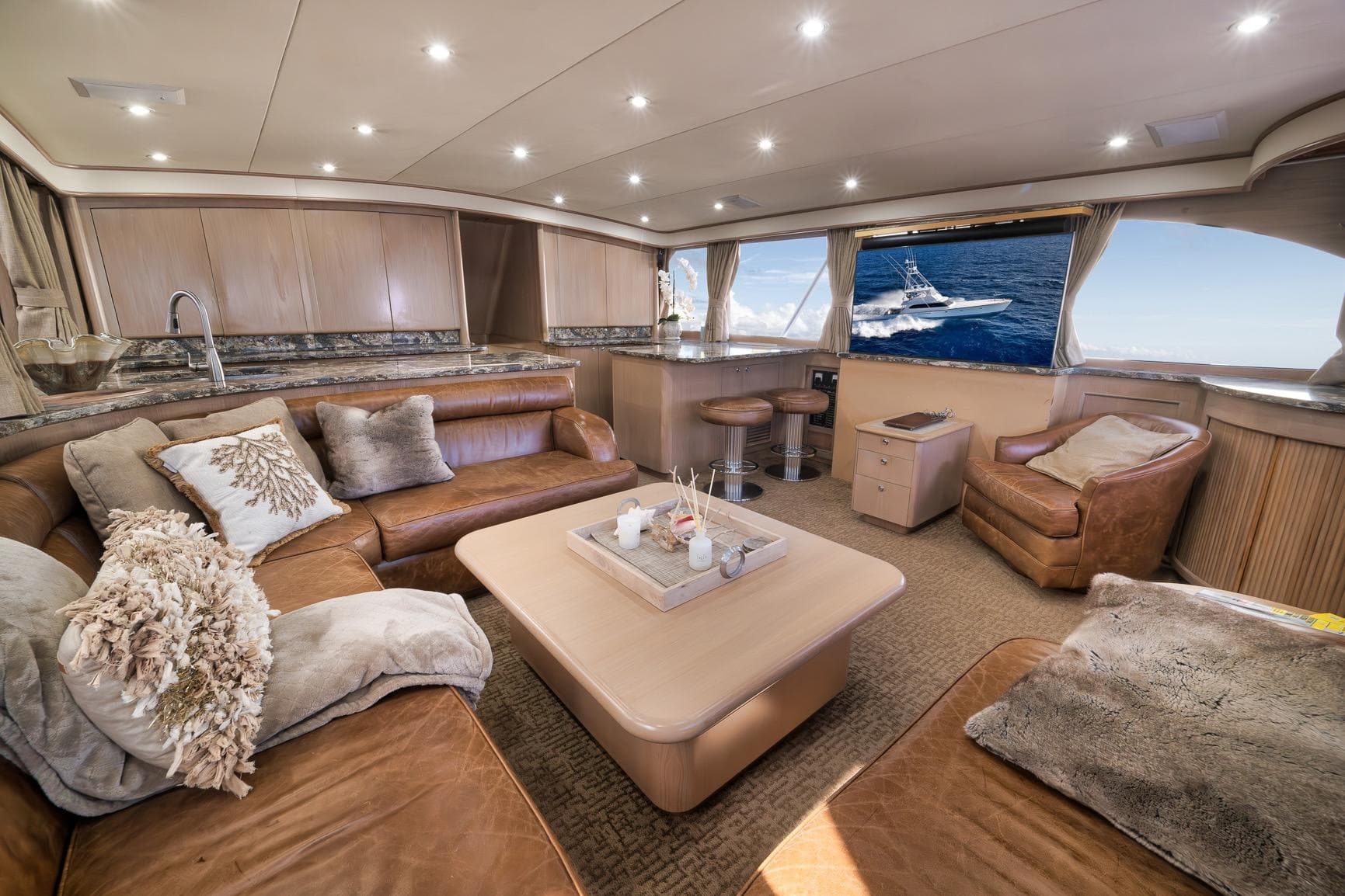Luxurious interior of a 1993 Merritt Sportfish yacht with plush seating and ocean view.