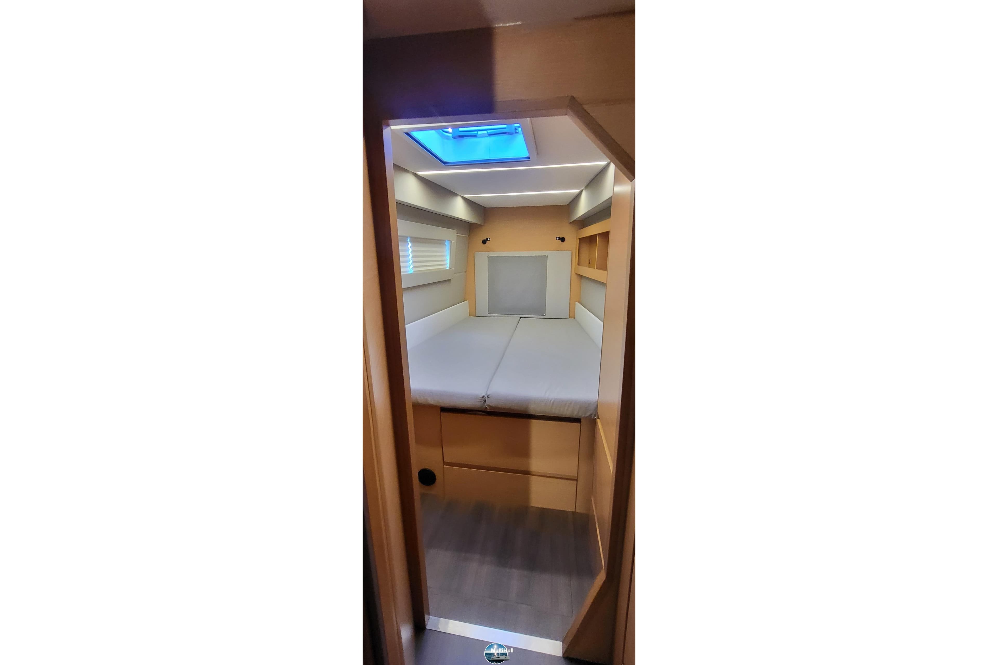 Interior cabin of 2018 Nautitech 46 Open catamaran, featuring a cozy bed and modern design.