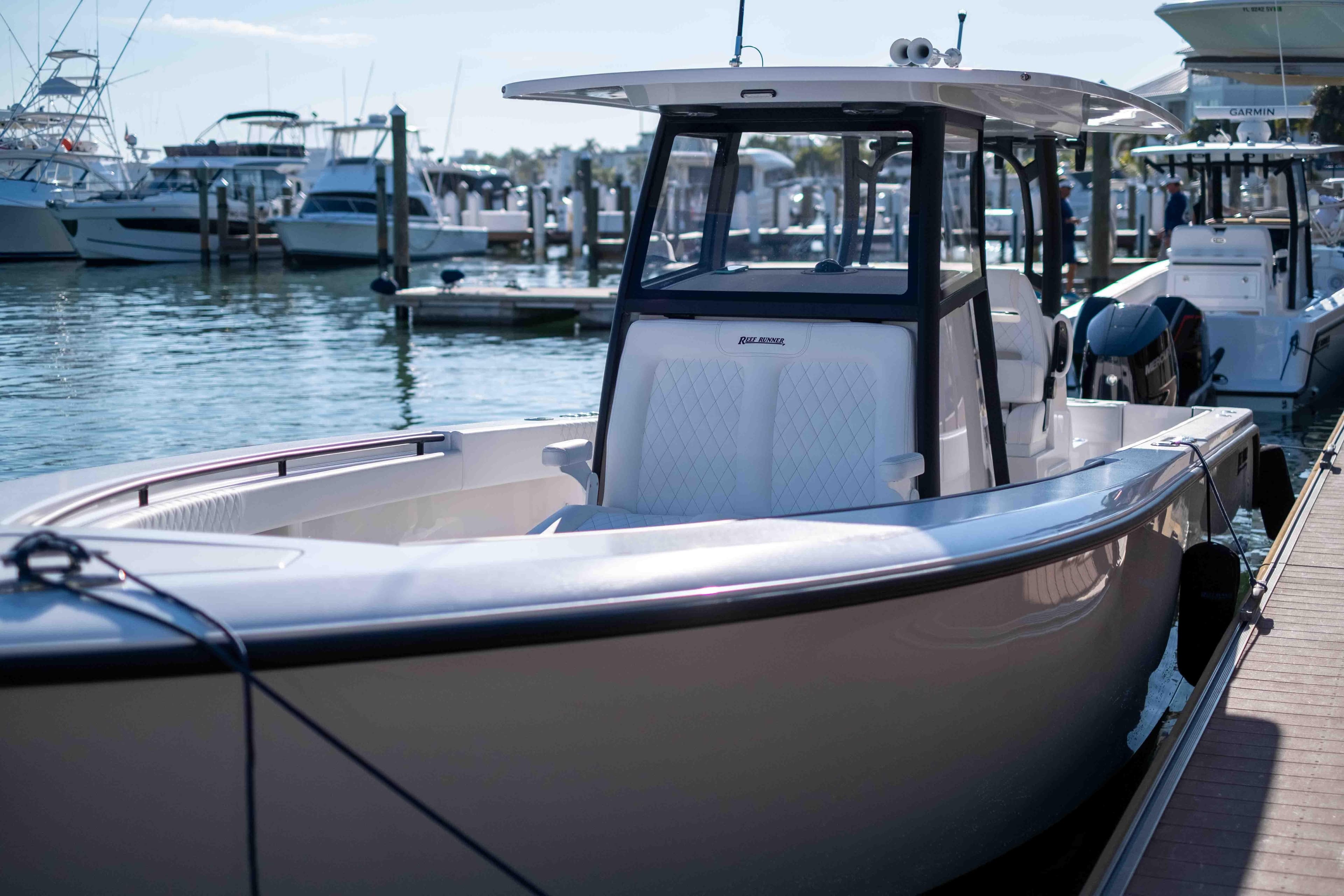 2026 Reef Runner 340 boat docked at marina, sleek design, sunny day.