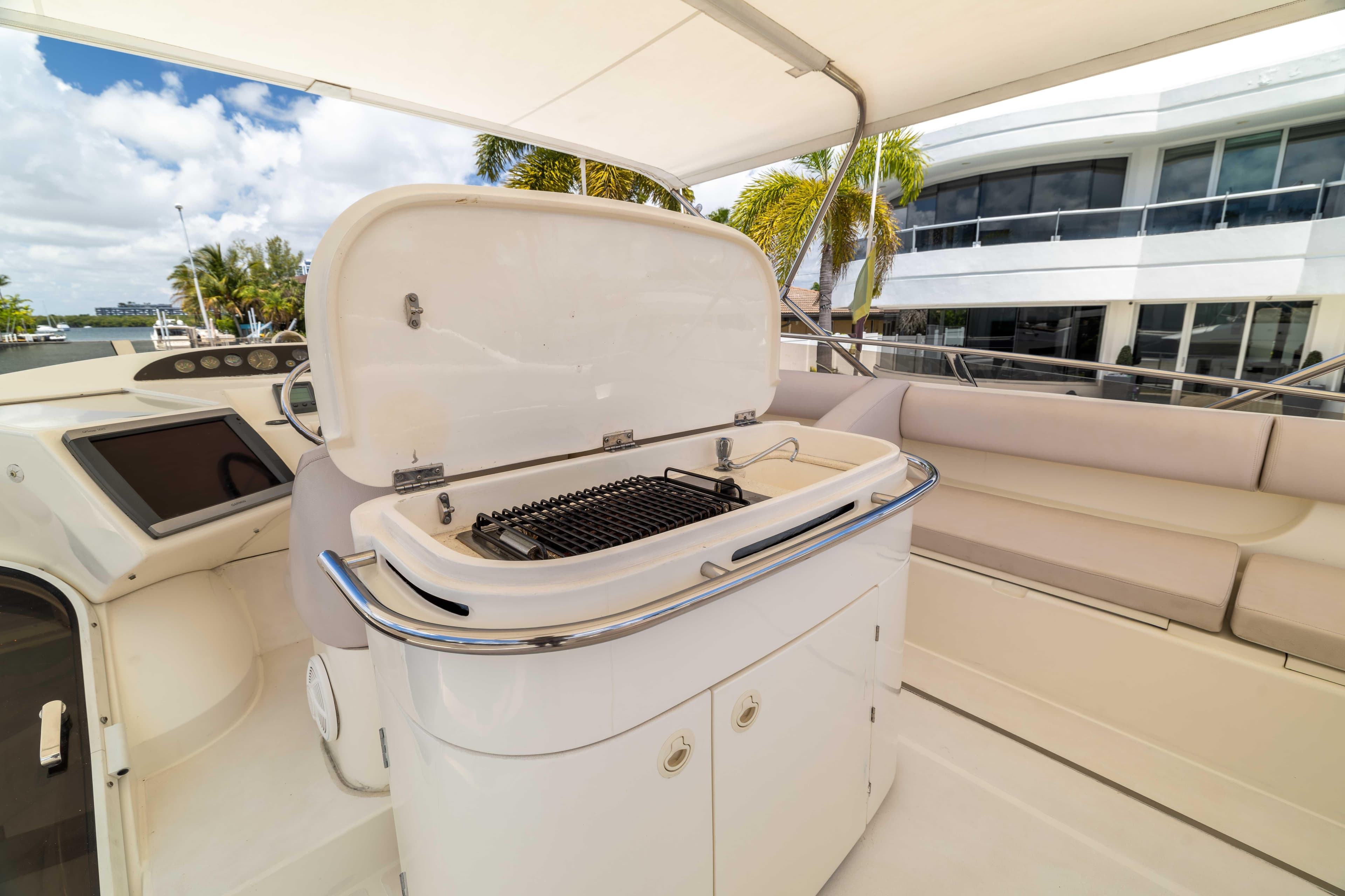 Luxury yacht Princess 61 (2002) with outdoor grill and seating area.