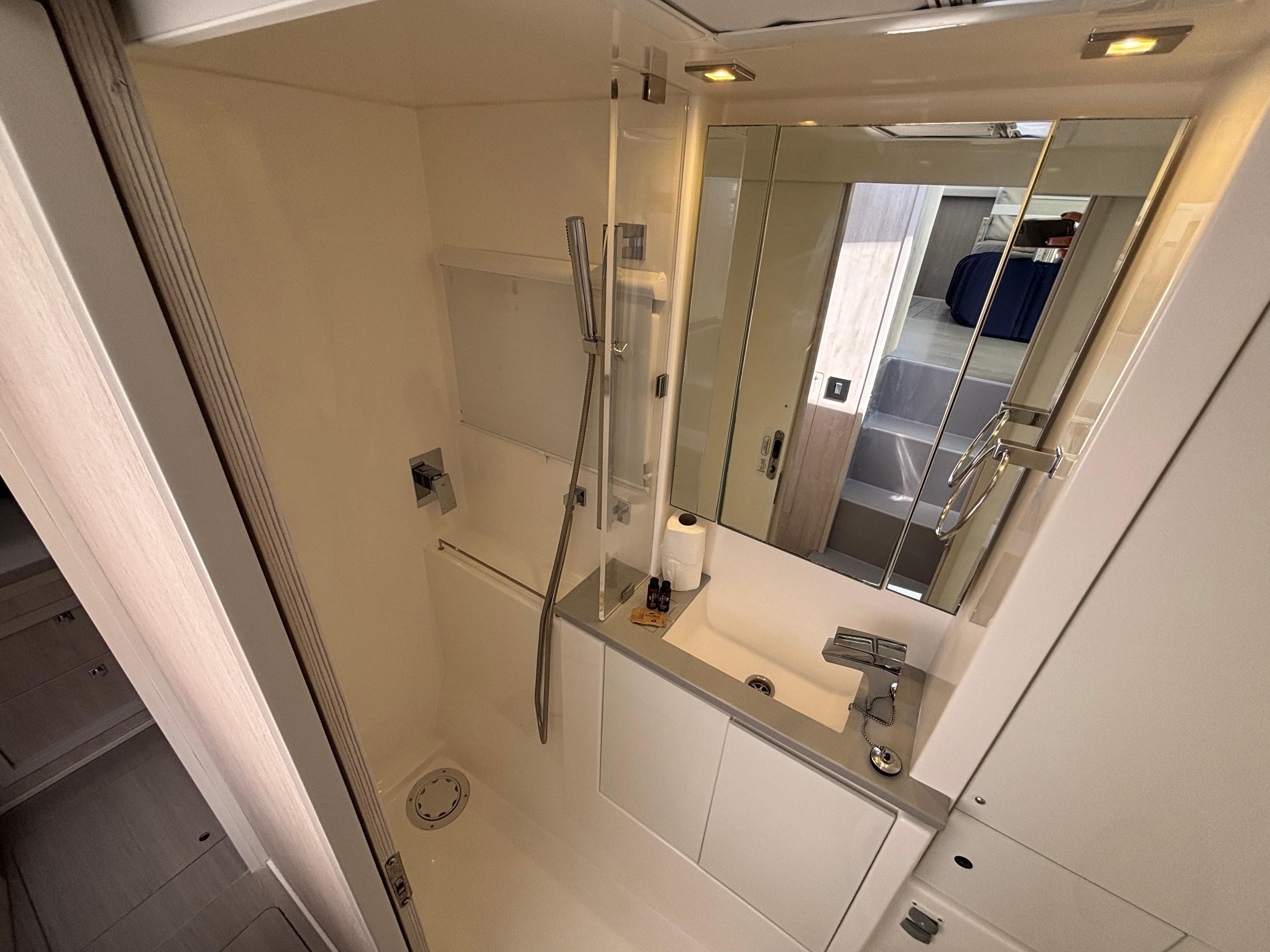 Modern bathroom in a 2019 Leopard 40 yacht with shower and sink.