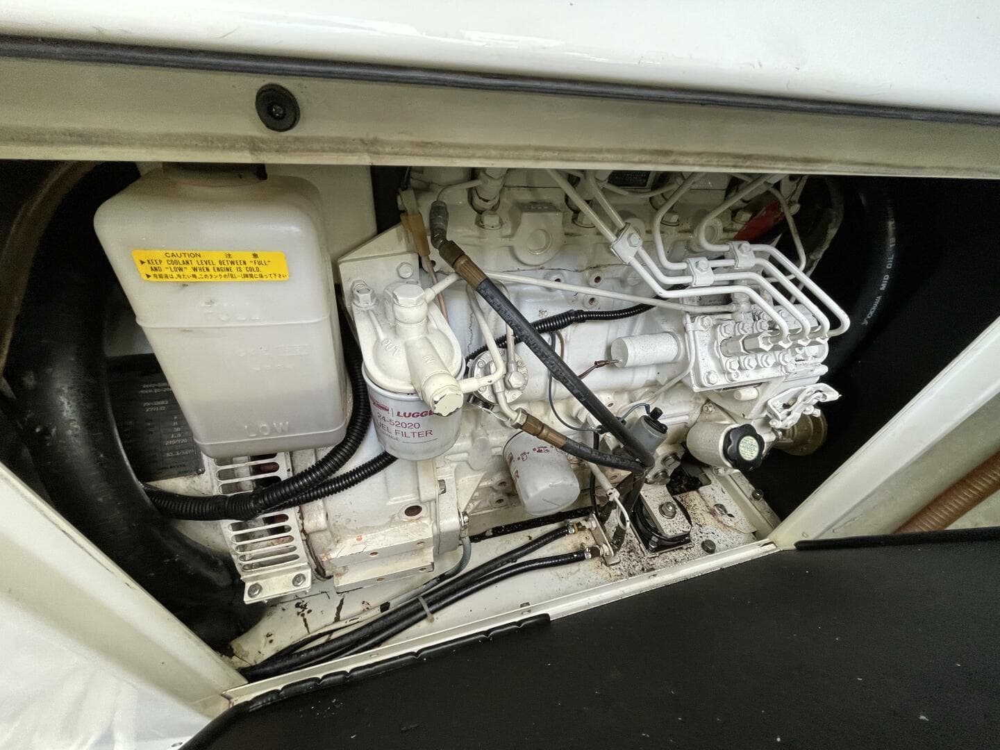 Engine compartment of a 2016 Leopard 58 yacht, showcasing mechanical components and wiring.