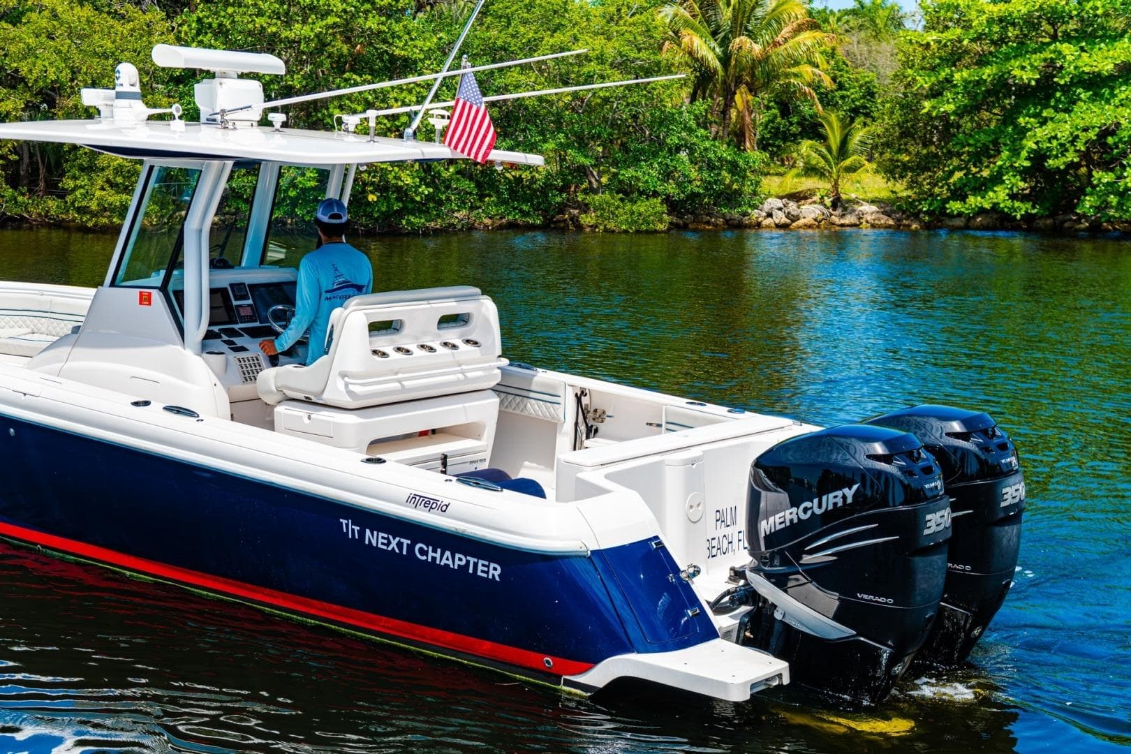 2018 Intrepid 327 Center Console boat cruising on a scenic waterway.