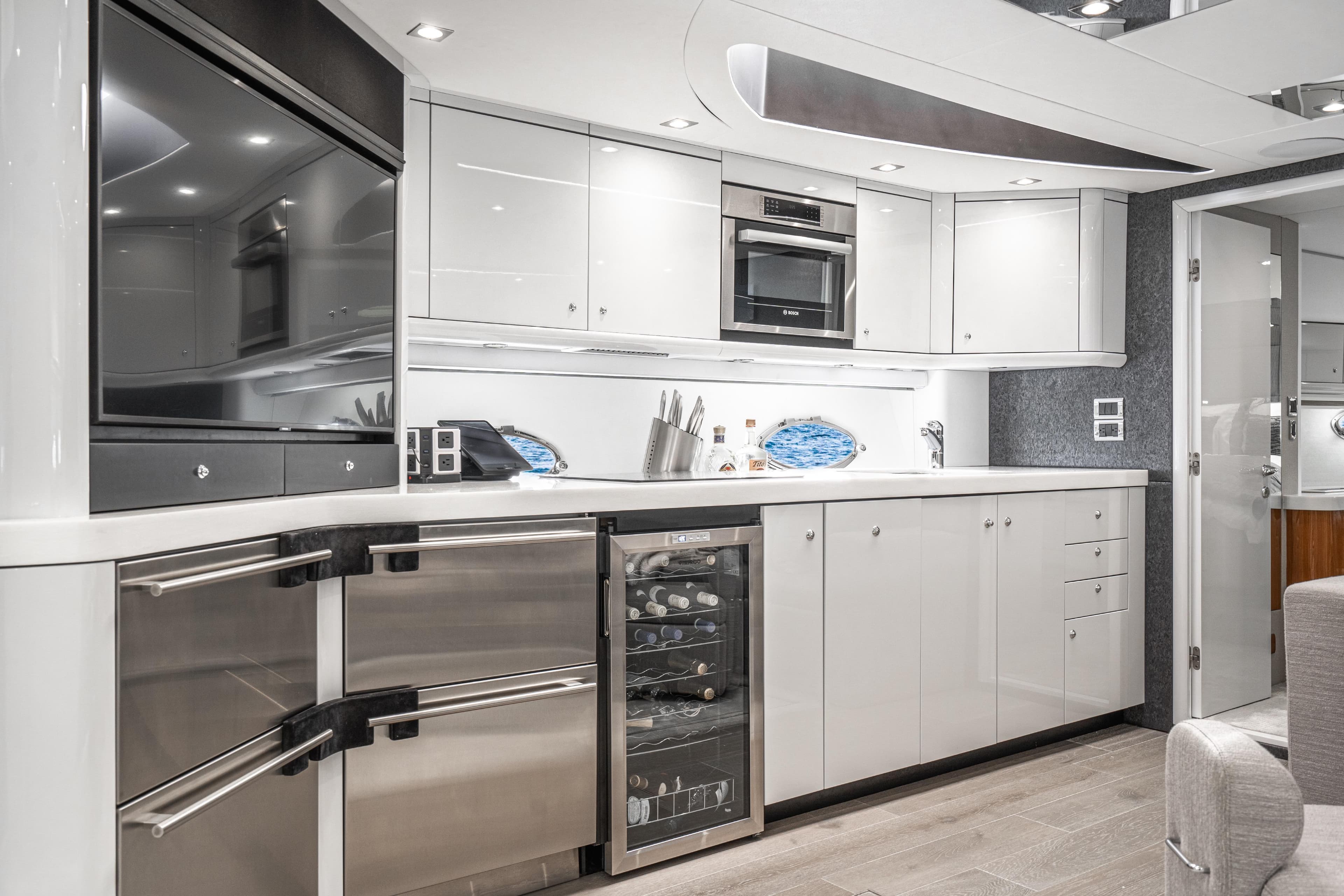 Luxurious kitchen interior of 2021 Sunseeker Predator 68 yacht with modern appliances.