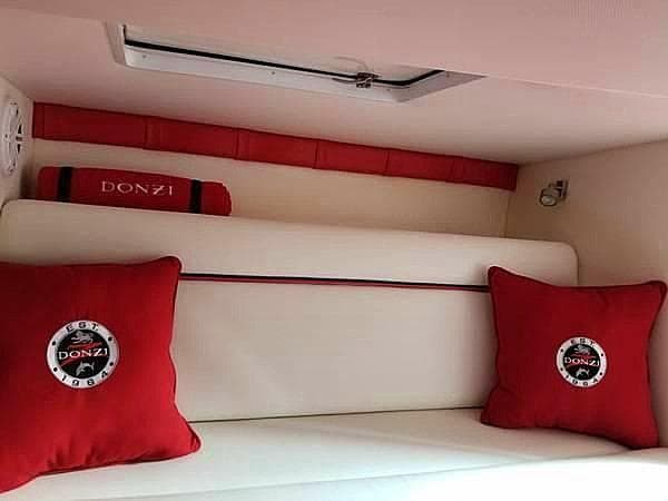 2008 Donzi 35 ZR cabin interior with red cushions and white seating.