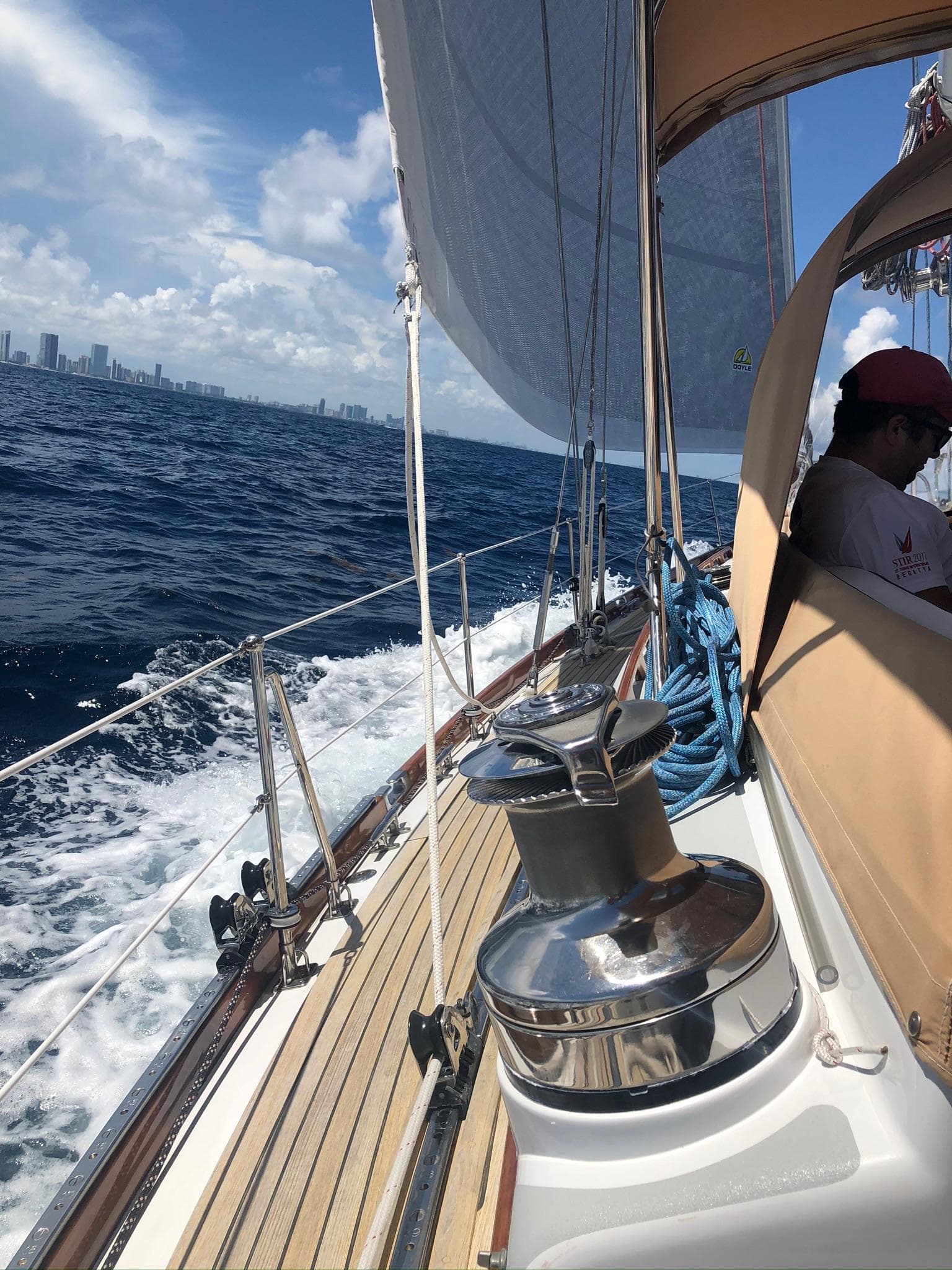Sailing on a 1989 Little Harbor 54 yacht with city skyline in the background.