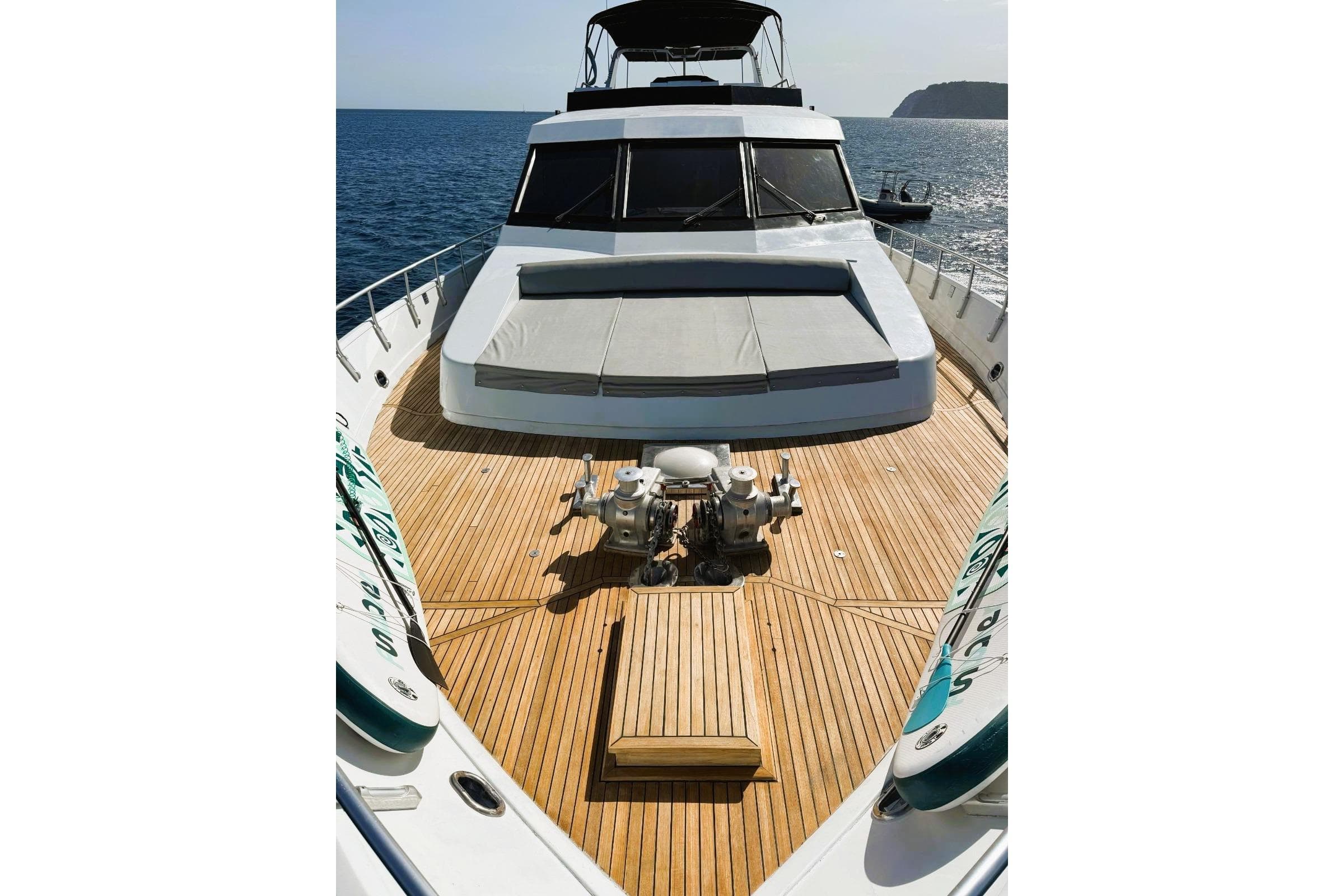Luxury Canados 88 yacht deck, 1987 model, with sunbathing area and ocean view.