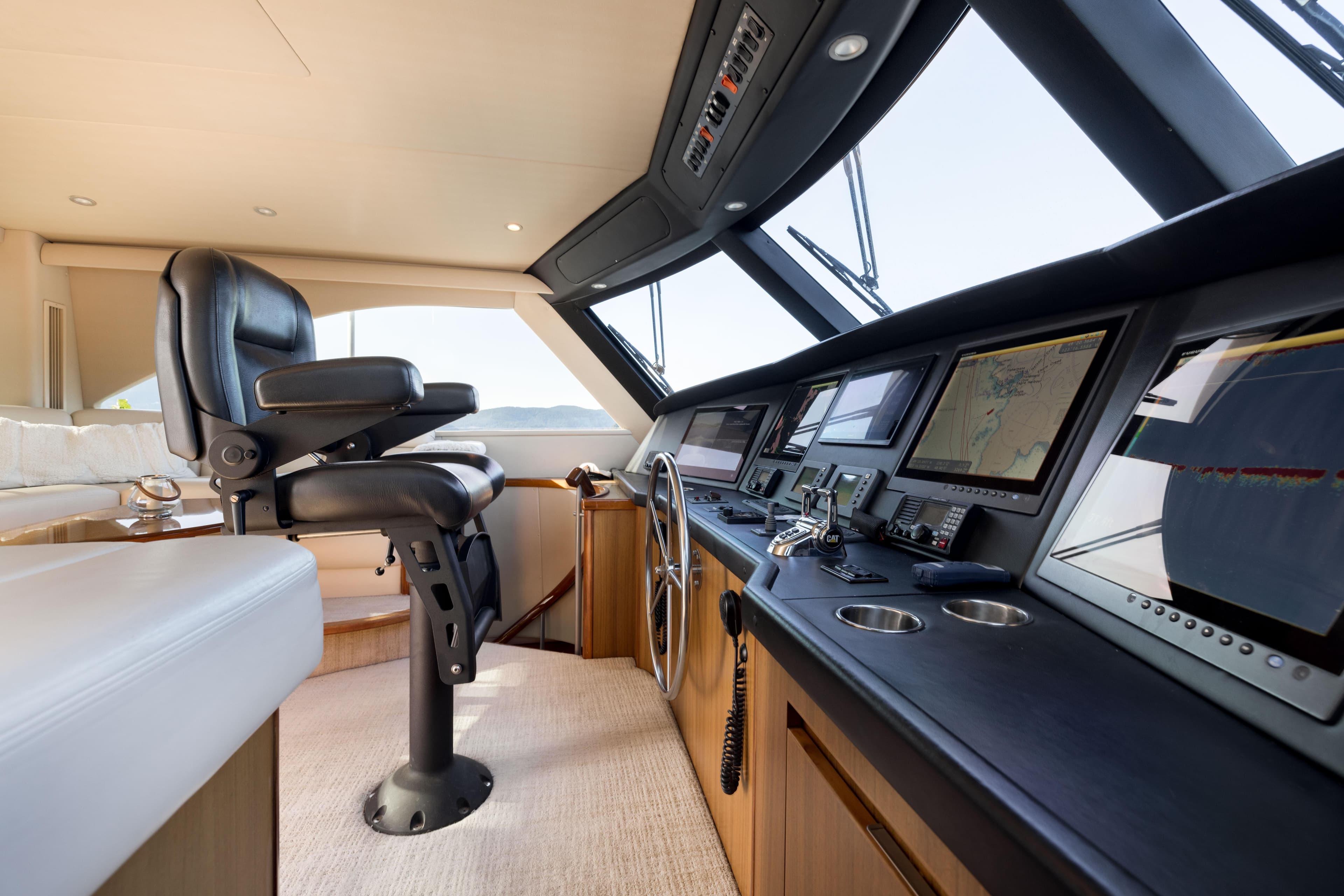 Luxurious helm of 2010 Viking 60 Enclosed Bridge yacht with advanced navigation systems.