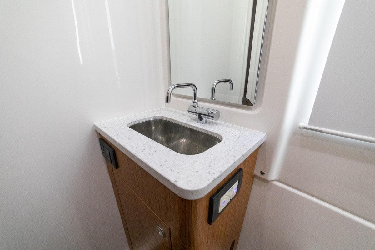 Manufacturer Provided Image: 2024 Solace 41 CS bathroom sink with modern faucet and mirror
