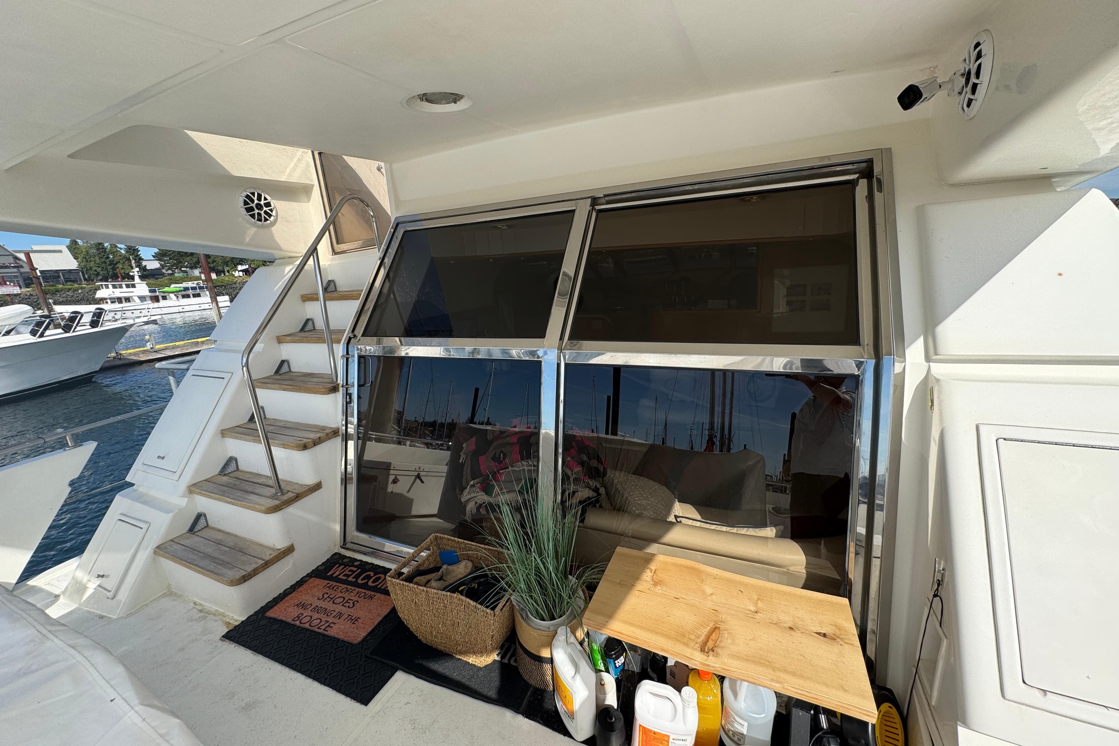 1994 Johnson High-Tech 65 Euro yacht deck with stairs, seating, and dockside view.