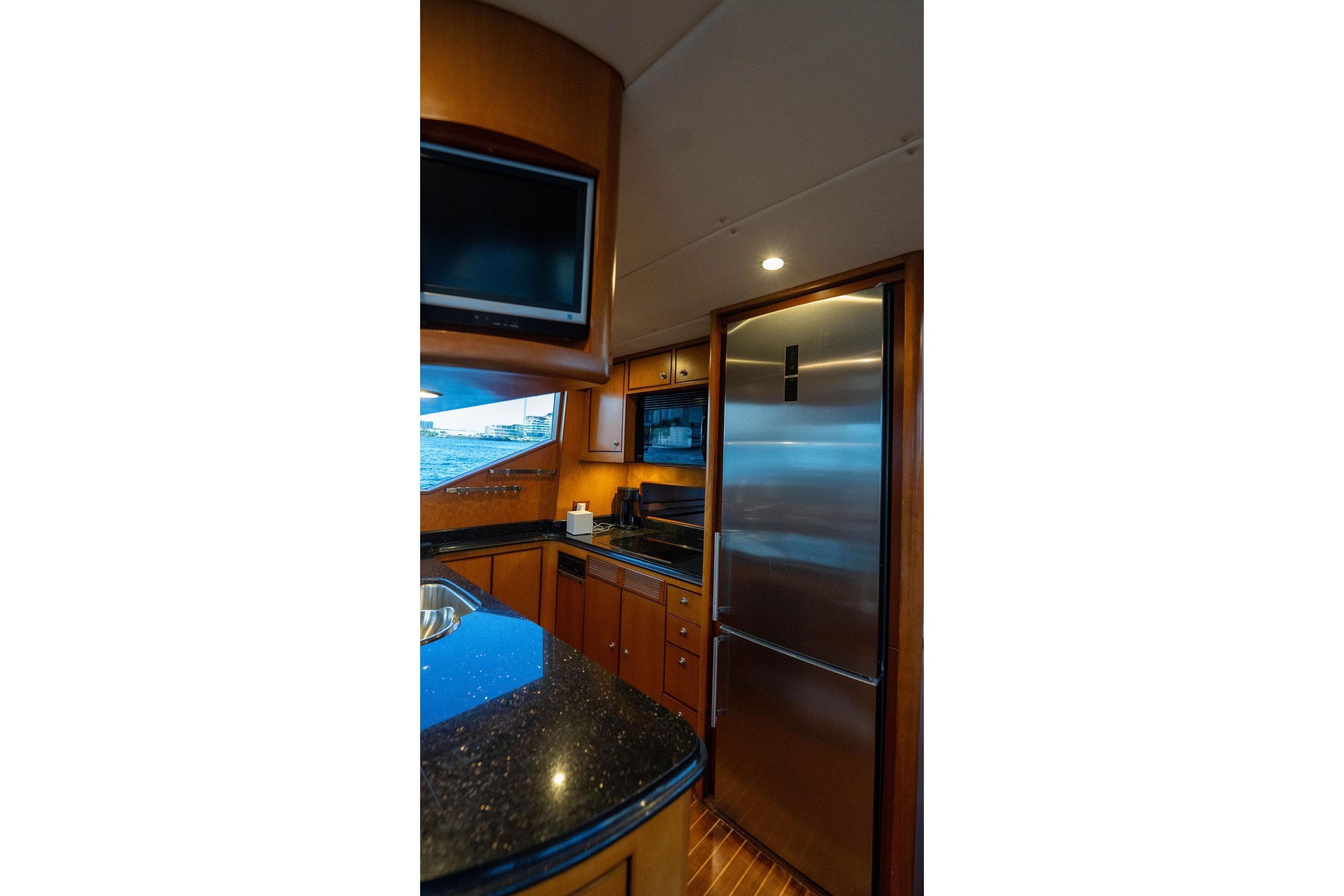 Luxurious kitchen interior of 2005 Symbol 58 Pilothouse yacht with modern appliances.