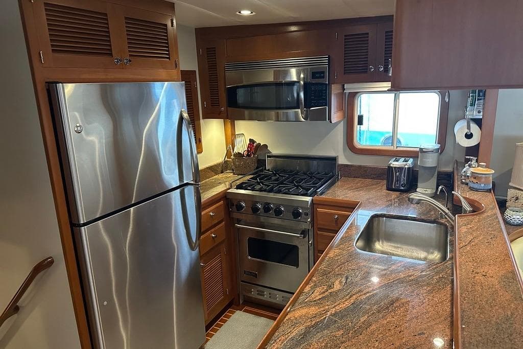 Luxurious 2011 Kadey-Krogen 48 AE yacht kitchen with stainless steel appliances and granite countertops.