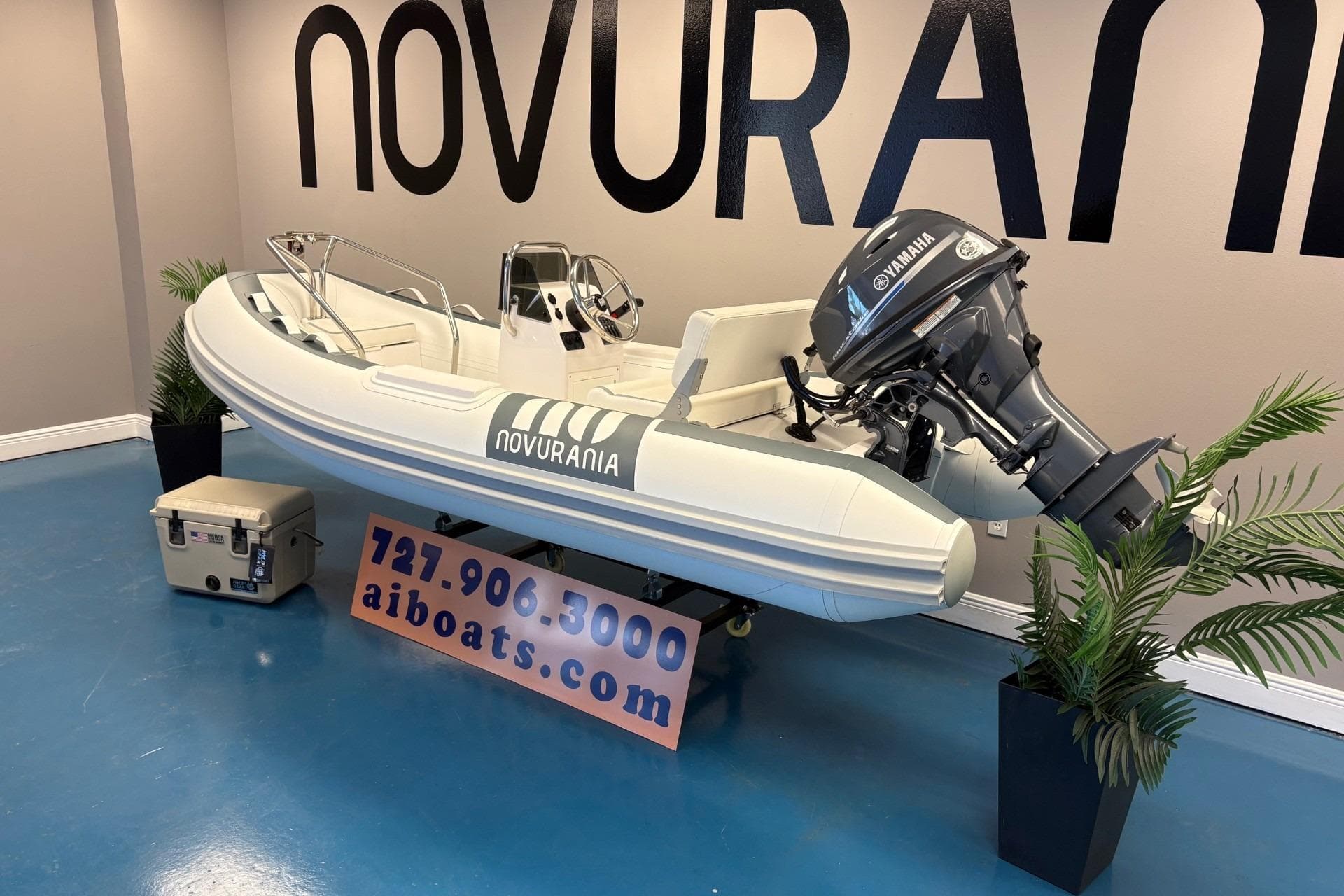 2025 Novurania DL 335 boat with Yamaha 25 HP engine displayed indoors.