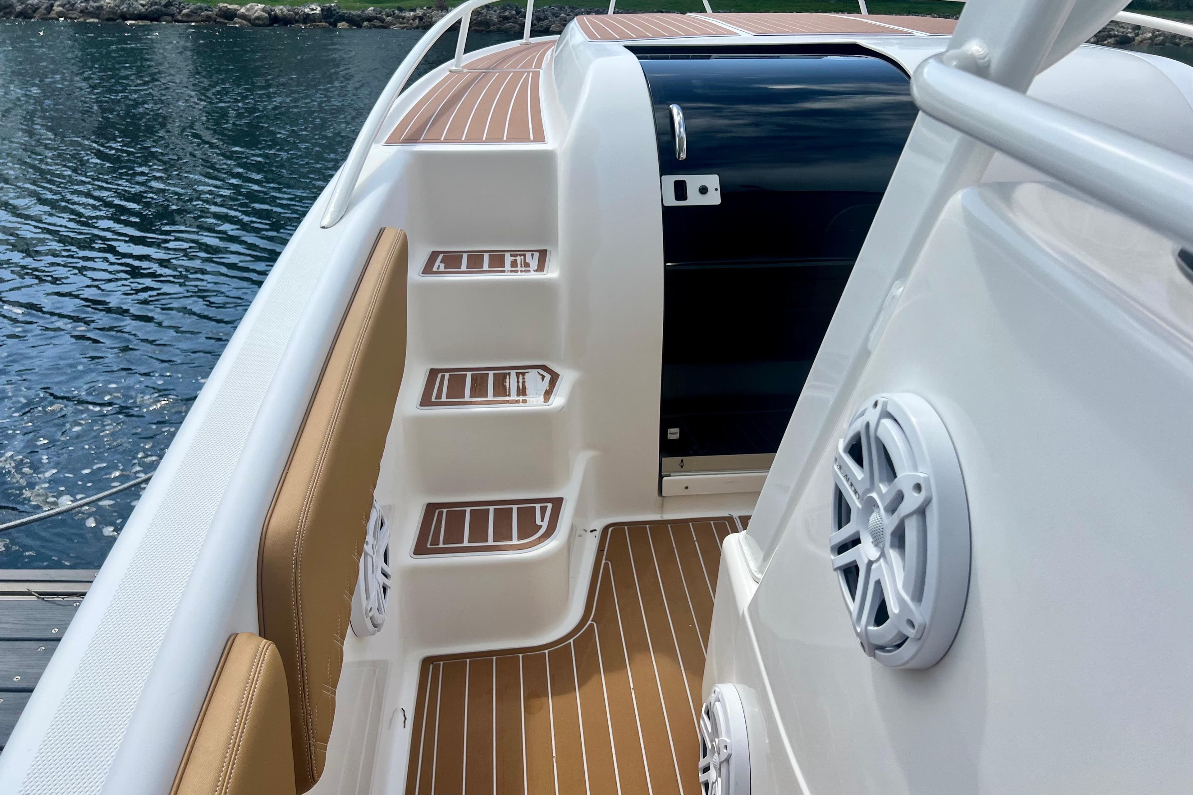 2011 Deep Impact 36 Open boat interior with teak flooring and marine speakers.