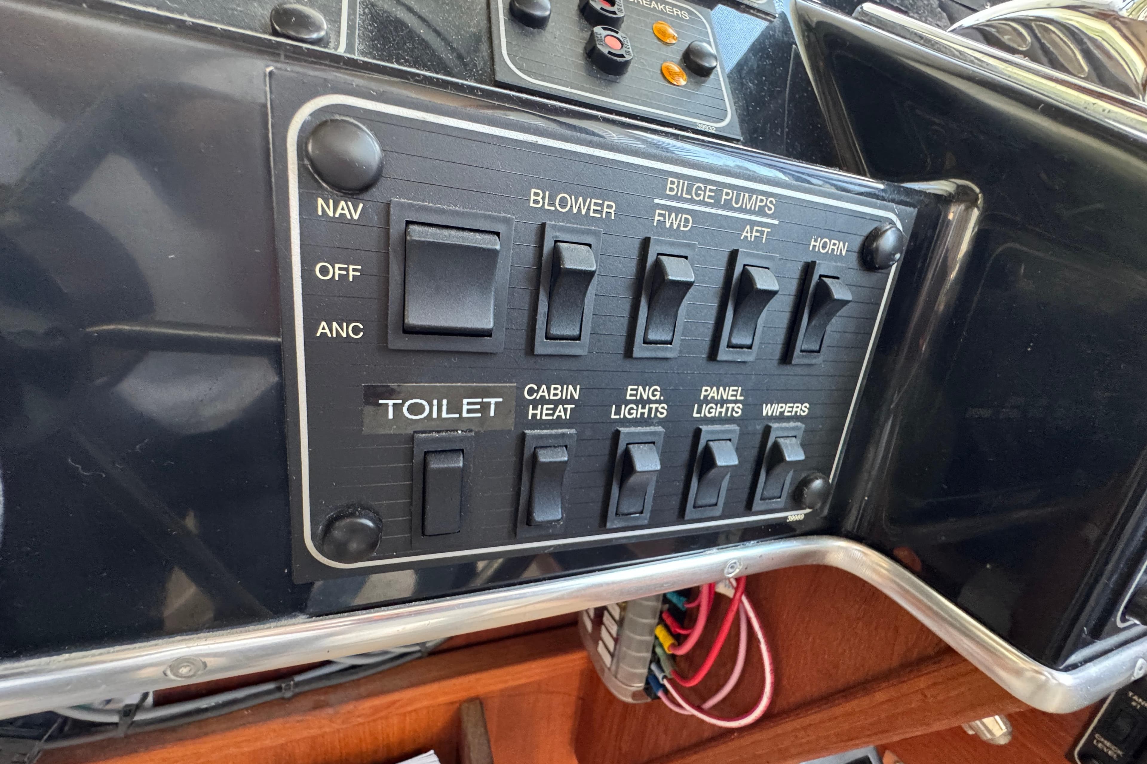Control panel of a 1995 Bayliner 3288 Motoryacht with various switches and labels.
