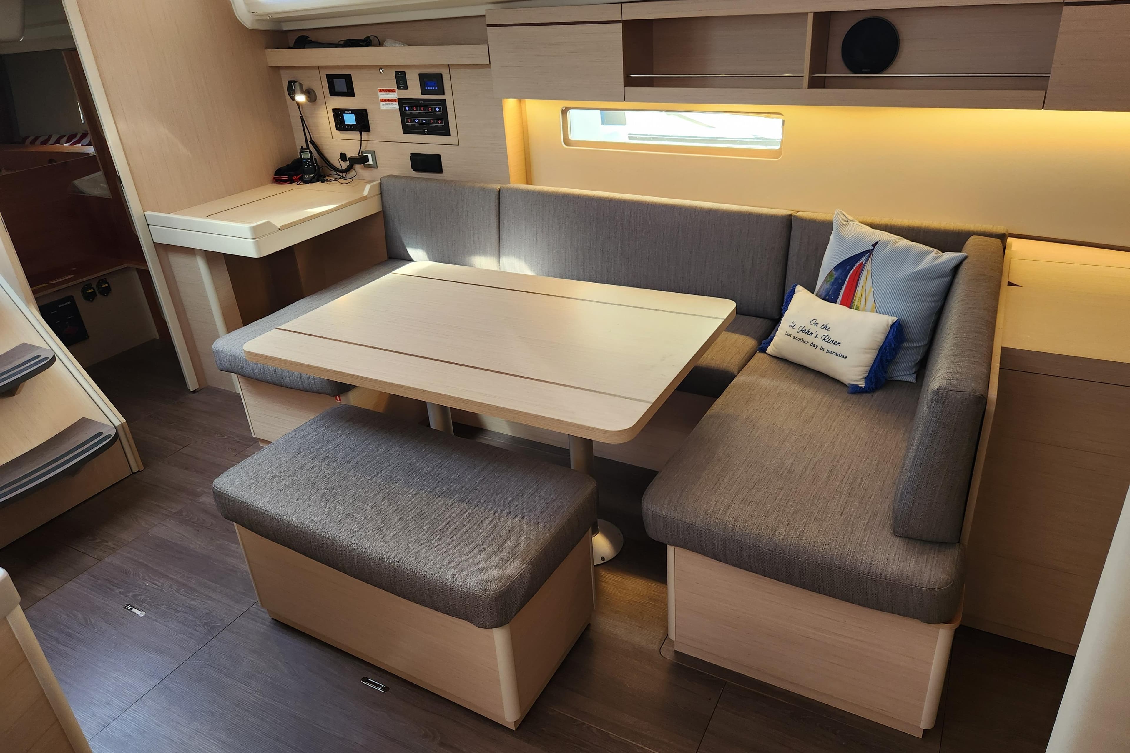 Modern interior of 2022 Beneteau Oceanis 40.1 yacht with cozy seating and table.
