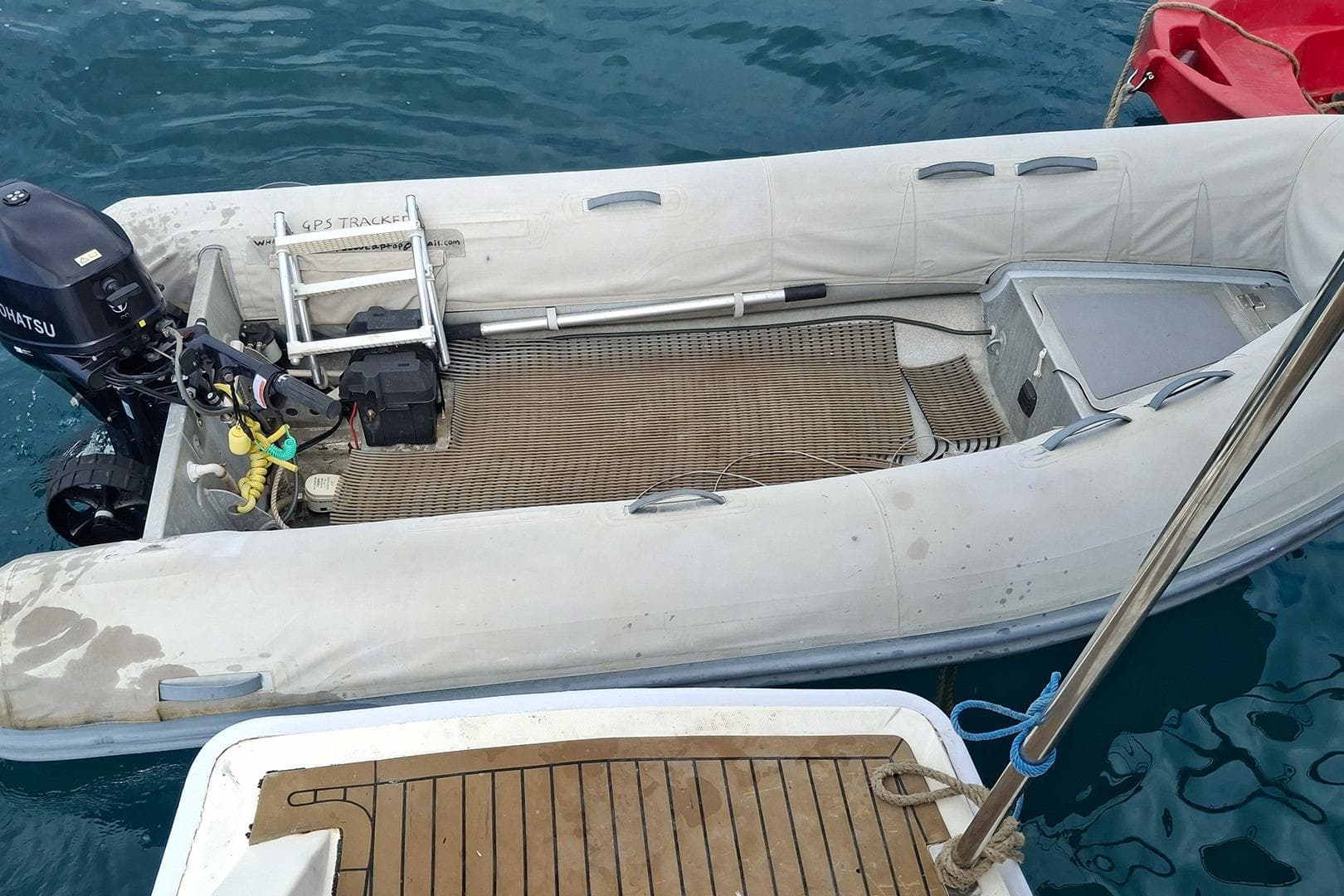 Inflatable boat with Tohatsu motor, docked on water, Leopard 48 model, 2013.