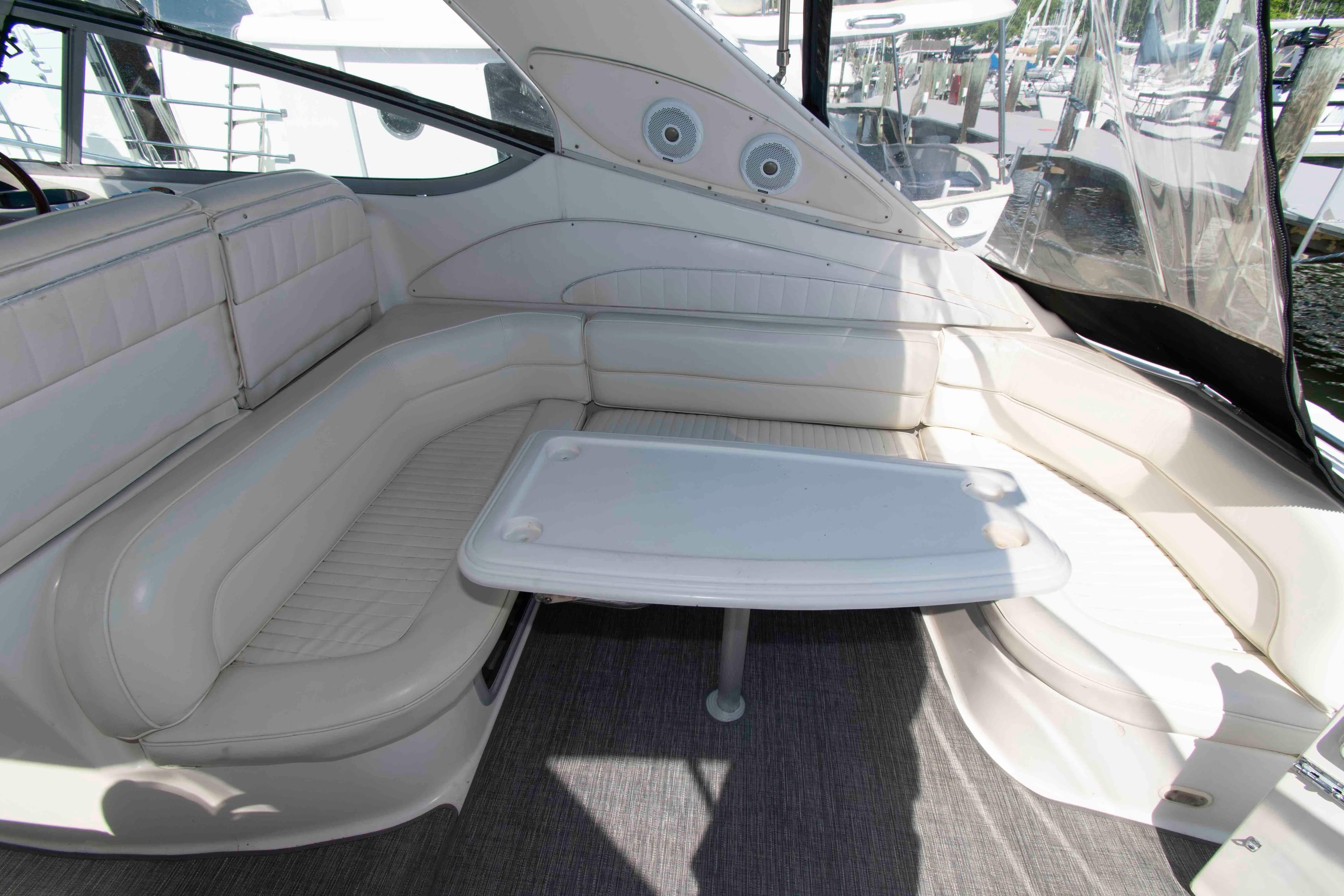 1998 Maxum 4100 SCR yacht interior with white seating and table.