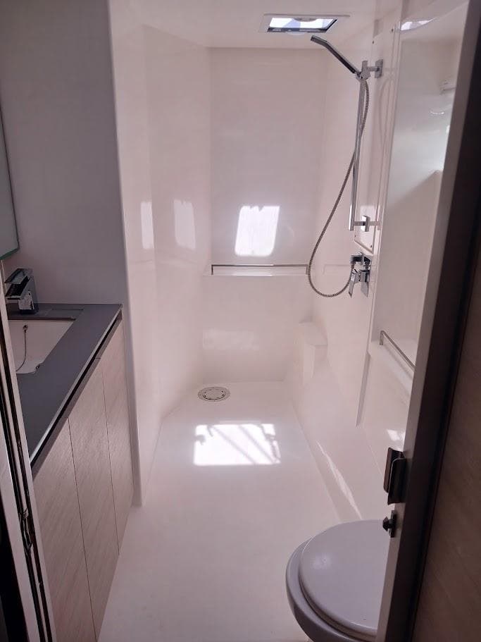 Modern yacht bathroom with shower, sink, and toilet in a 2020 Leopard 50 model.