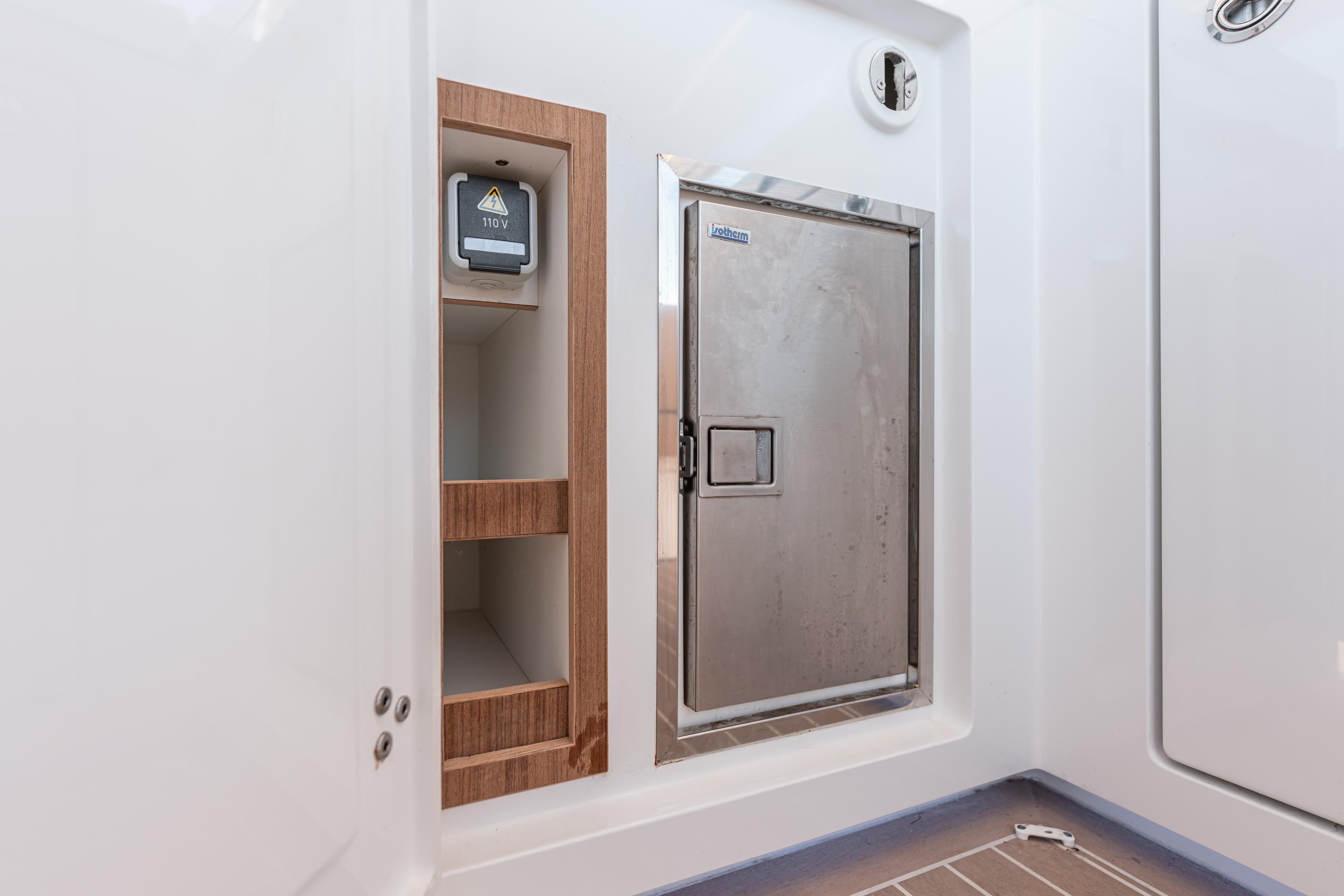 Interior of 2024 Fjord Boats 53XL featuring storage and electrical panel.