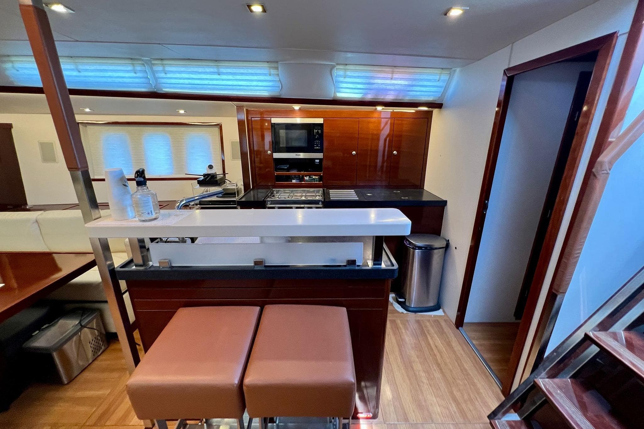 Luxurious interior of 2010 Hanse 630 e yacht with modern kitchen and seating area.