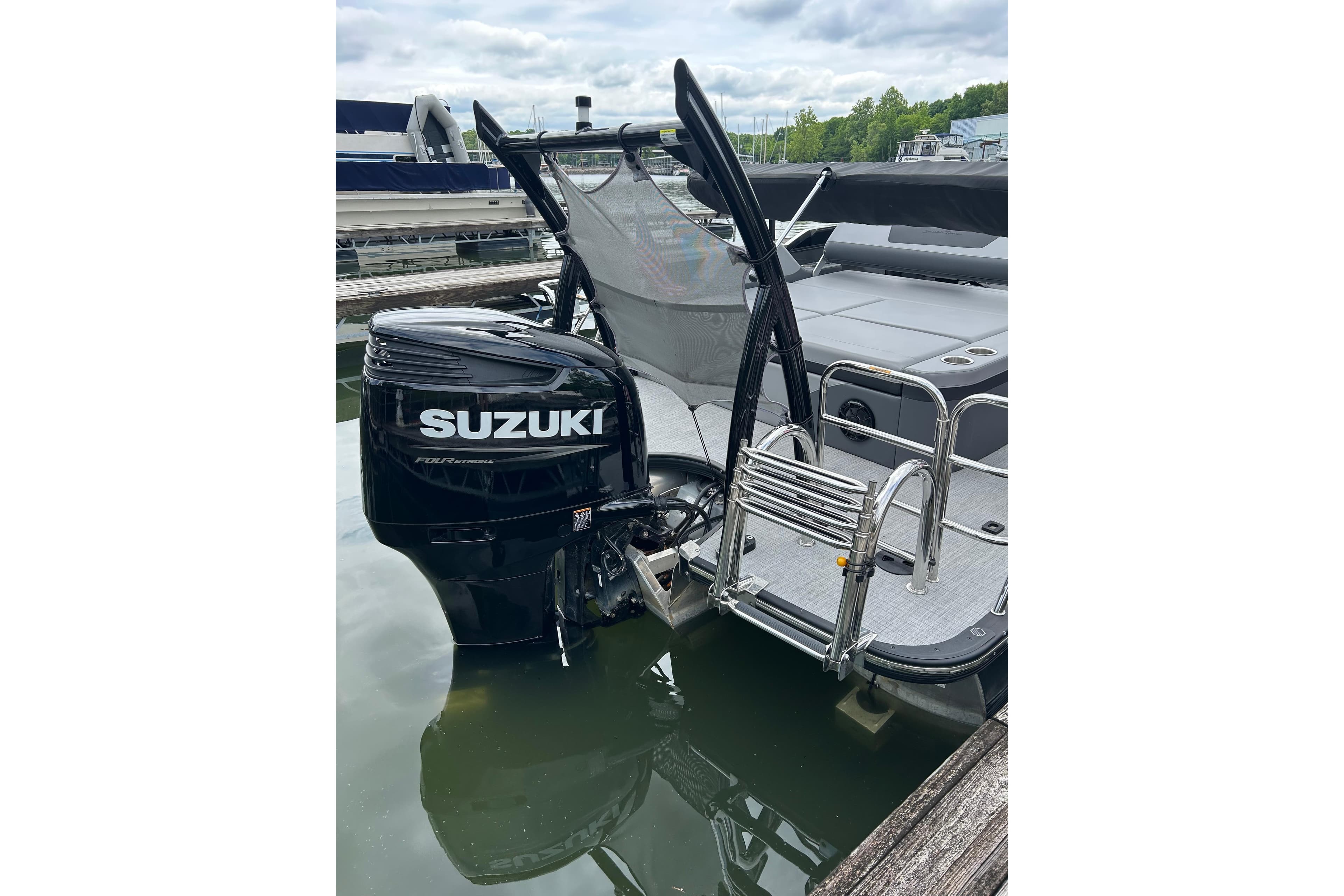 2025 South Bay 525UL393 boat with Suzuki outboard motor at dock.