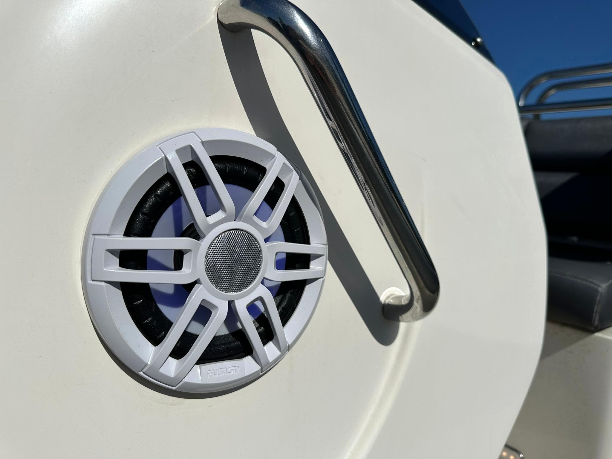 White speaker on a Revenger 715 boat, 2004 model, with stainless steel railing.