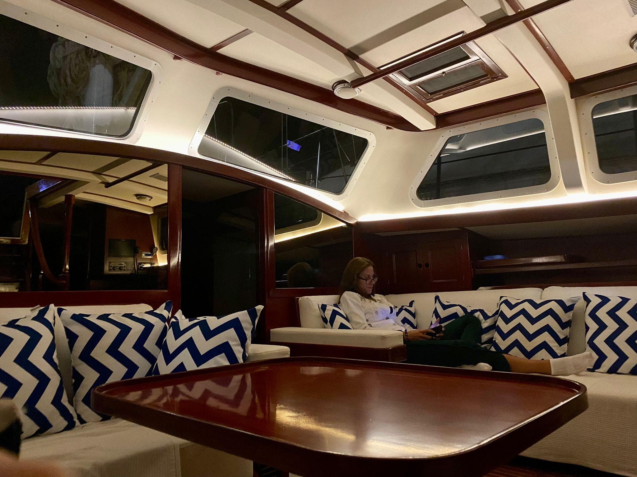 Luxurious interior of 1992 Ta Chiao 56 Ketch with cozy seating and chevron pillows.