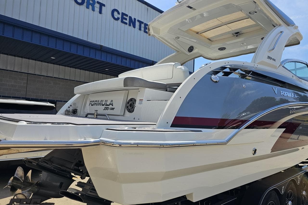 2020 Formula 330 Crossover Bowrider boat at a port center, showcasing sleek design.