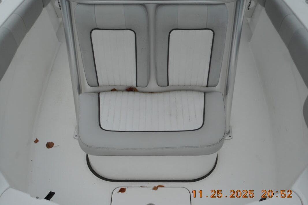 White cushioned seating on 2021 Sea Fox 228 Commander boat, with scattered leaves.