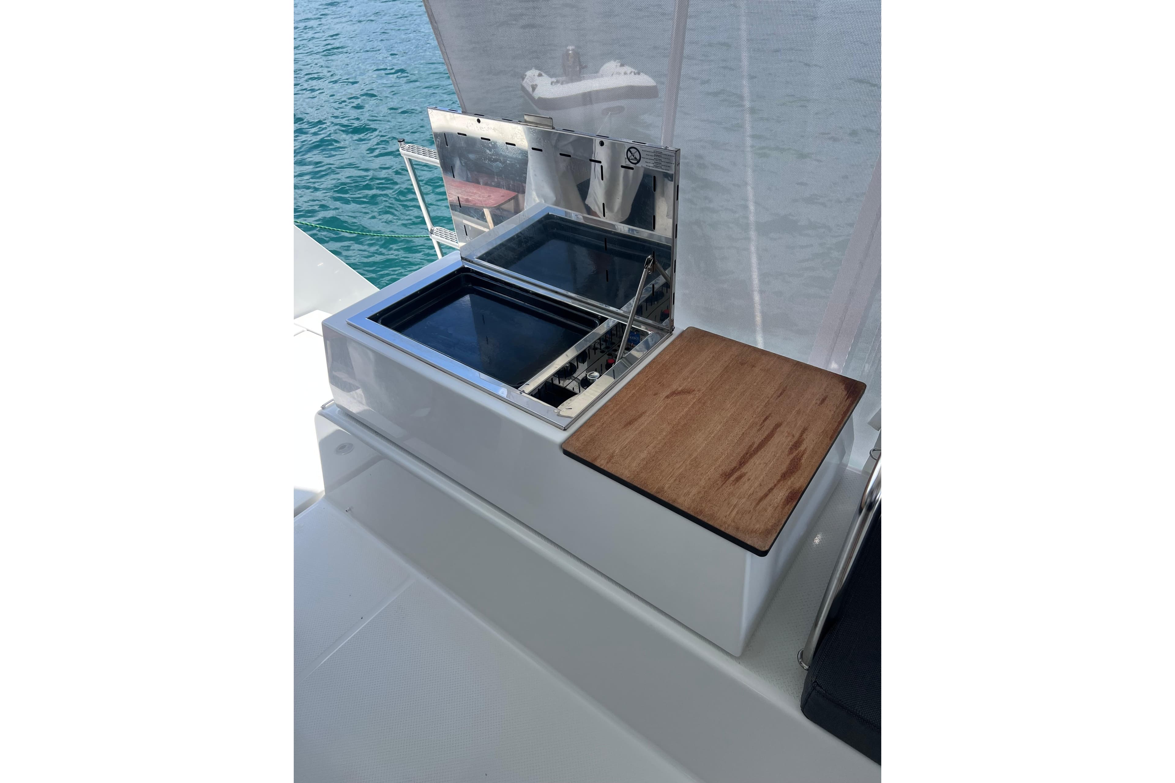 Outdoor kitchen area on 2023 Fountaine Pajot Astrea 42 Catamaran, featuring a grill and prep space.