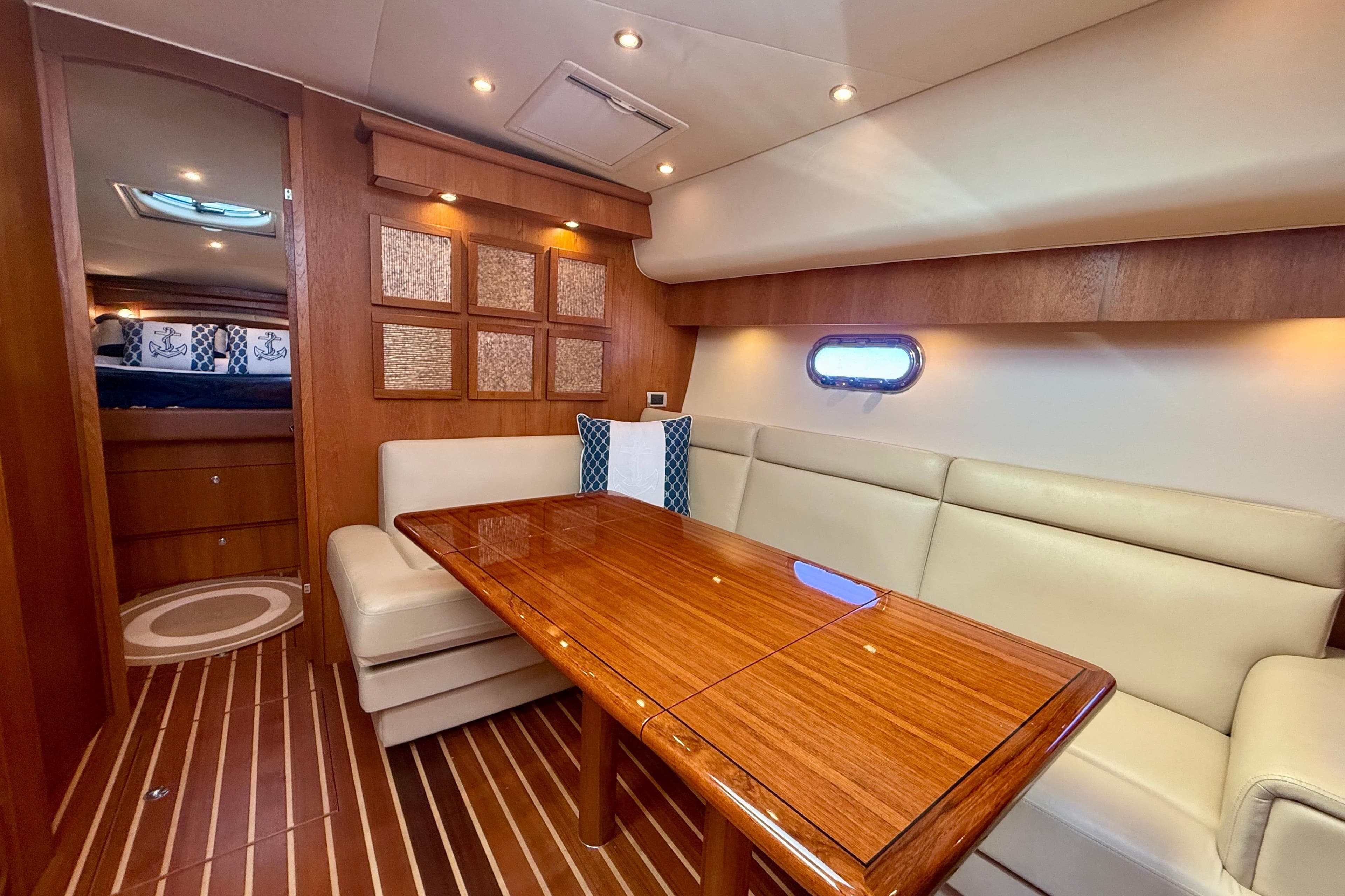 Luxurious interior of 2012 Tiara Yachts 4500 Sovran with elegant wood finishes and plush seating.