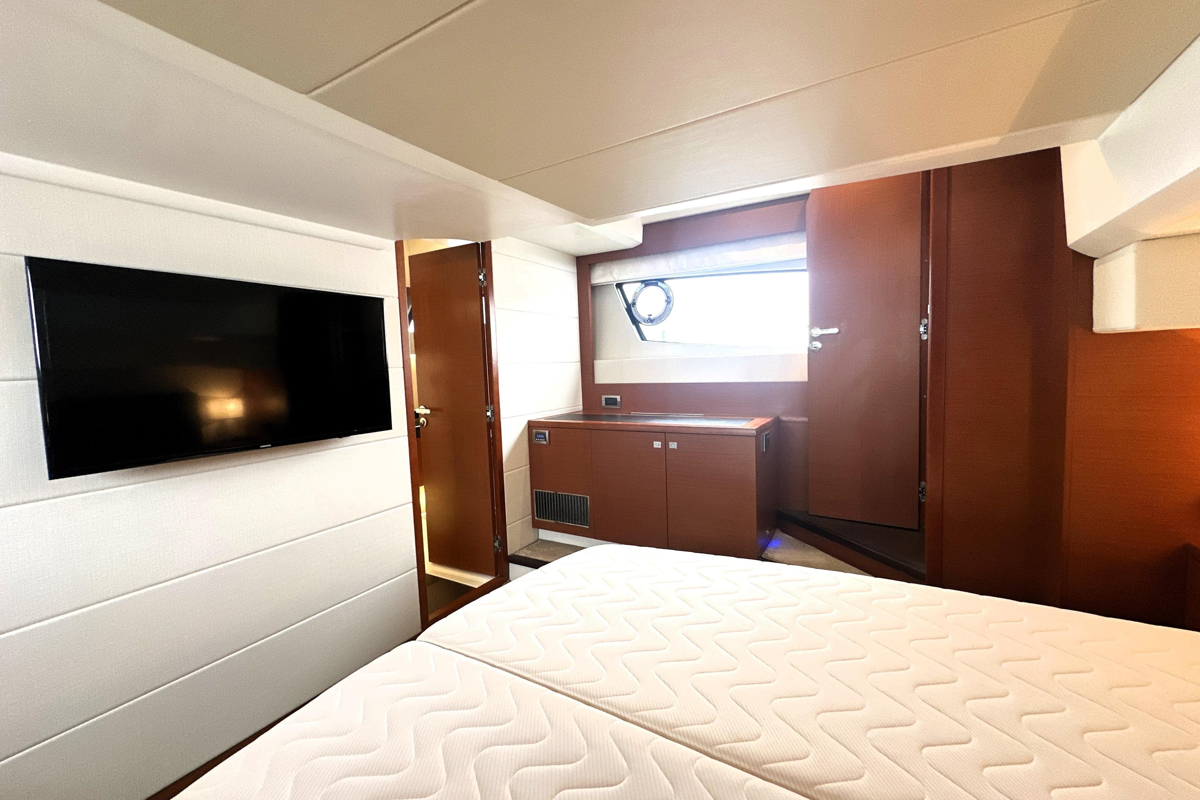 Luxurious interior of 2017 Prestige 500 yacht with TV and modern furnishings.