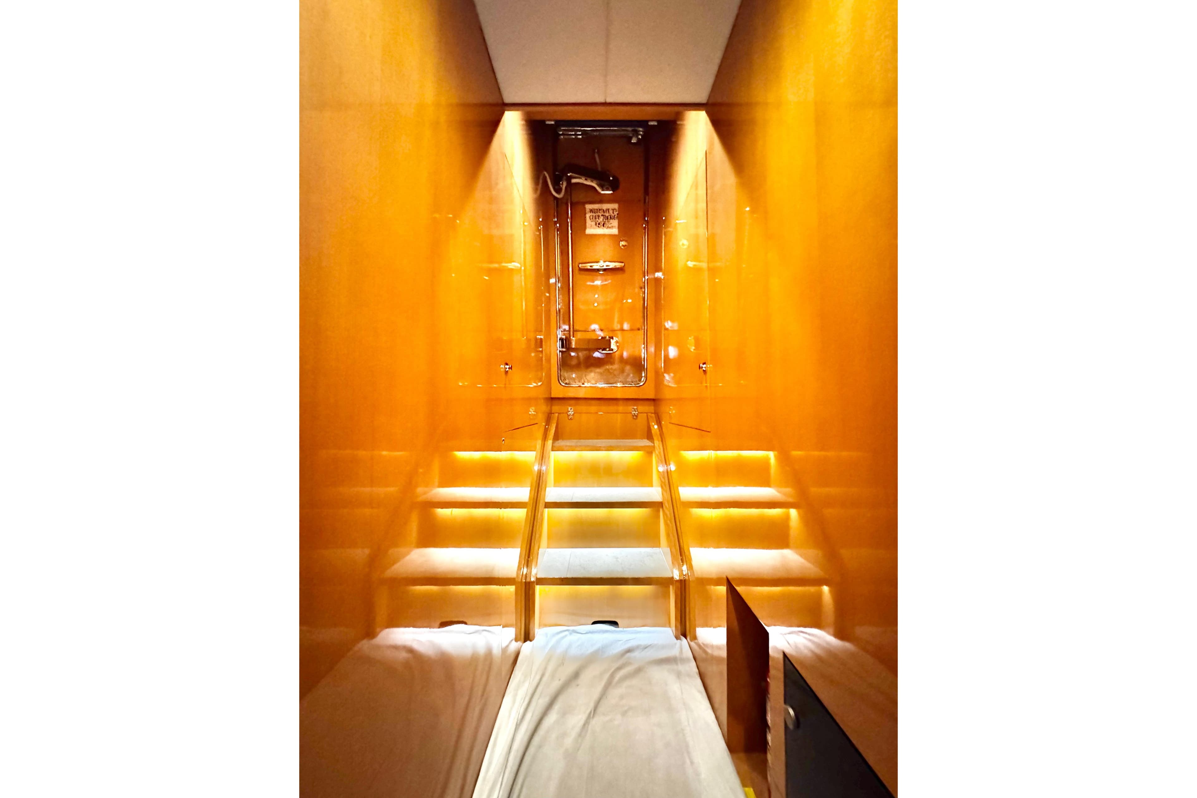 Luxurious interior of 2011 Horizon E88 yacht with illuminated wooden staircase.