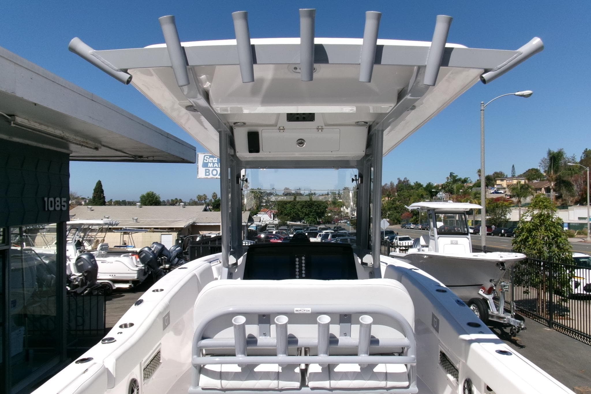 2026 Sea Fox 268 Commander boat with T-top and rod holders, docked at a marina.