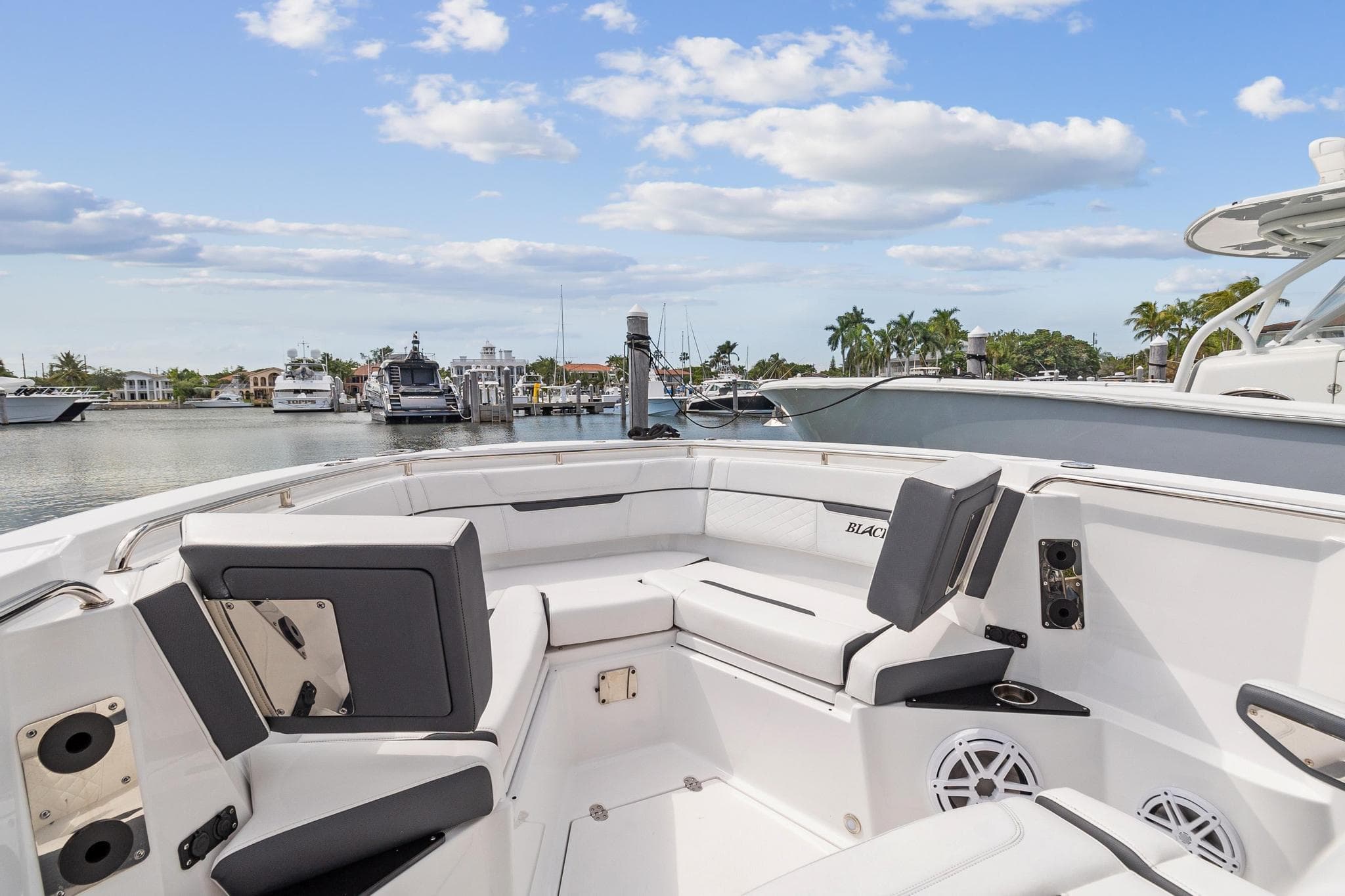 2022 Blackfin 272 CC boat interior with seating at marina.