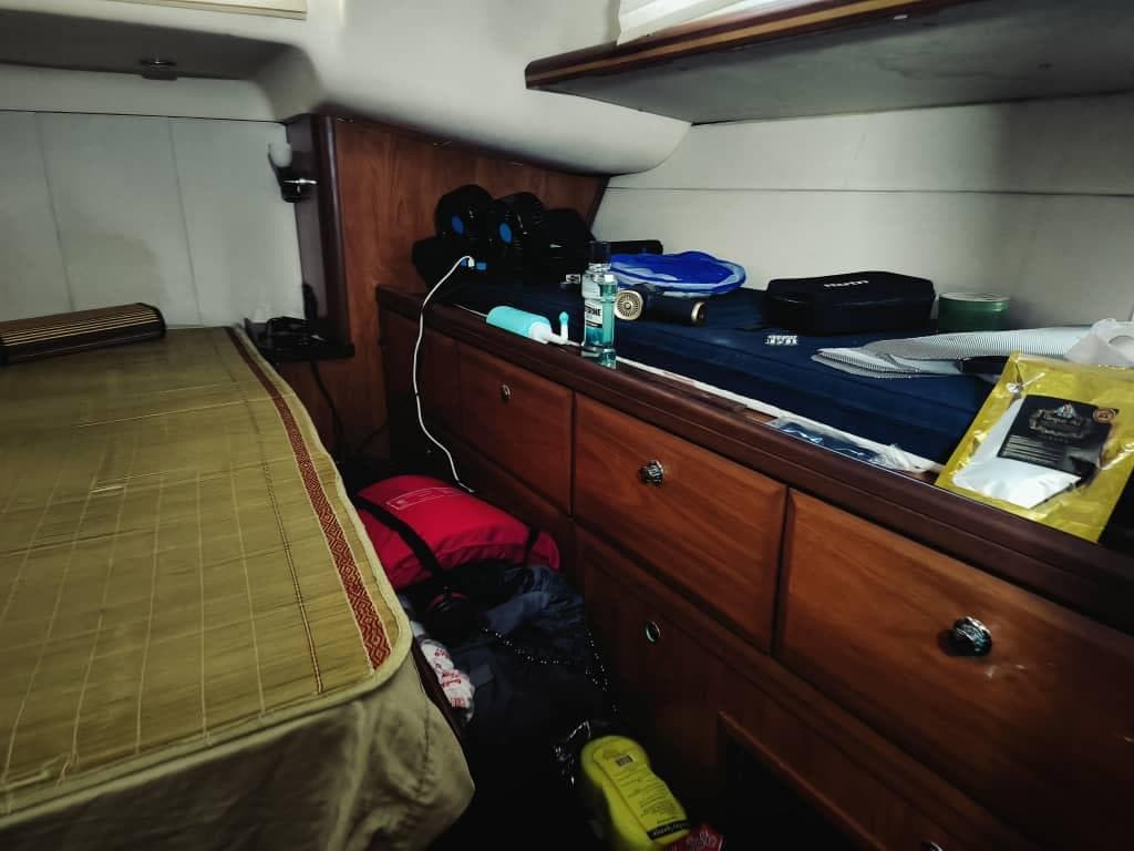 Cozy cabin interior of 2010 Hunter 50 Center Cockpit sailboat with storage and bed.