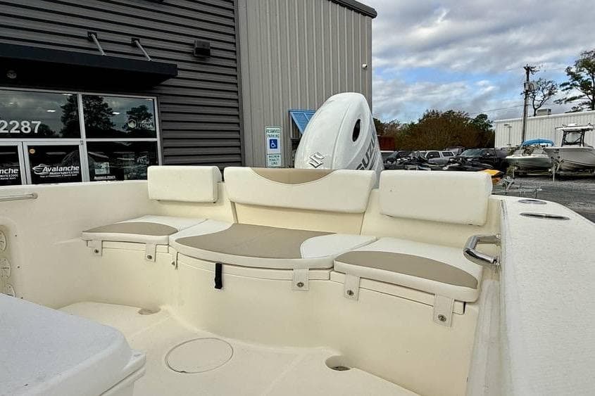 2026 Bulls Bay 230 Center Console boat interior with cushioned seating, parked outside dealership.