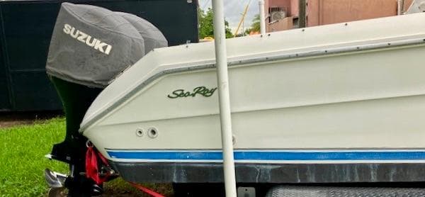Sea Ray 240 Sundeck 1990 boat with Suzuki outboard motor.