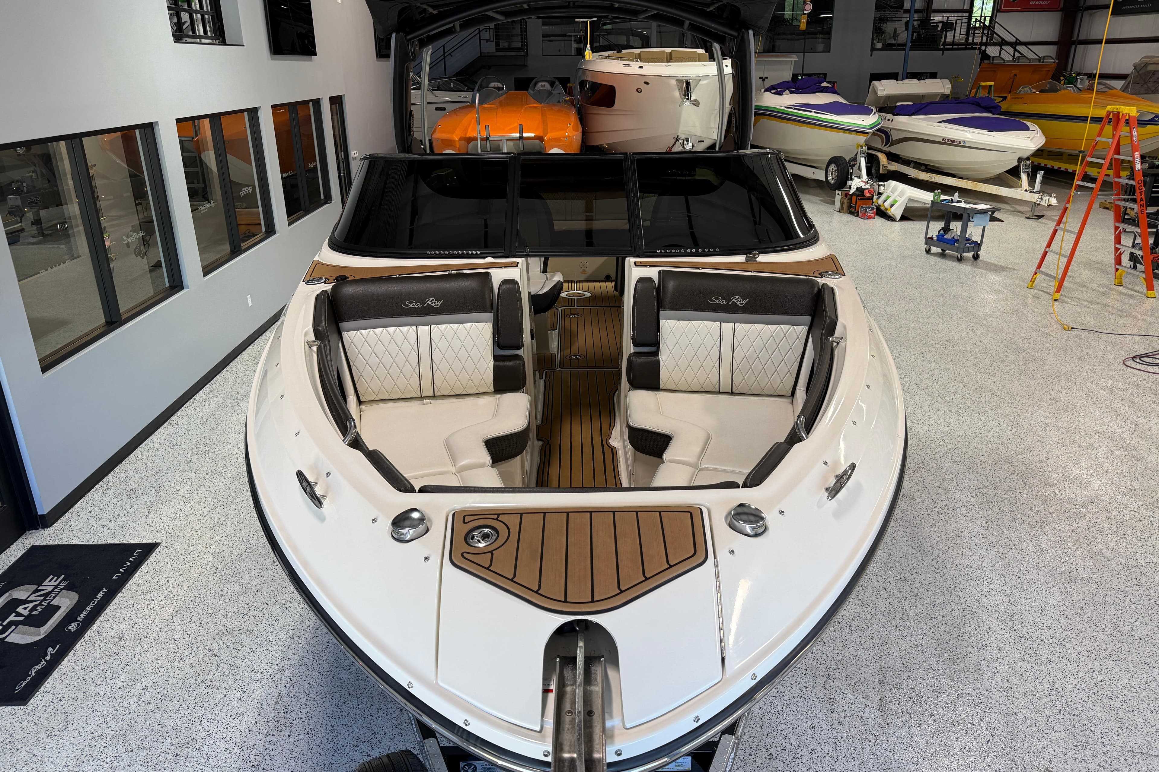 2017 Sea Ray SLX 280 boat in showroom, featuring luxurious seating and sleek design.