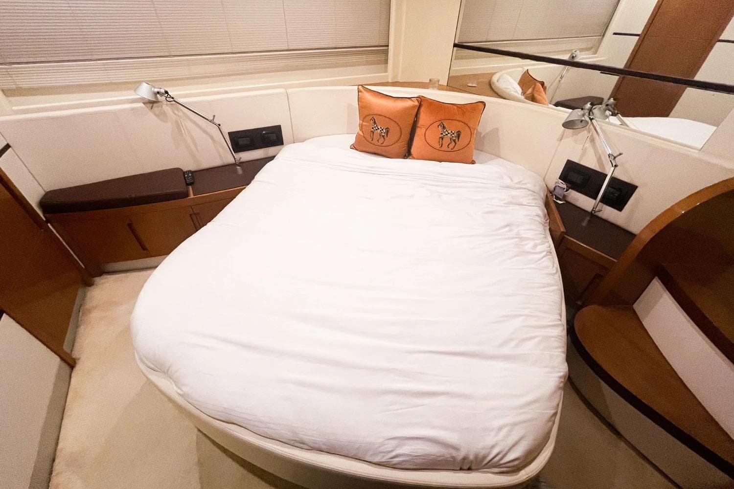 Luxurious bedroom interior of 2007 Pershing 62' yacht with elegant bedding and decor.