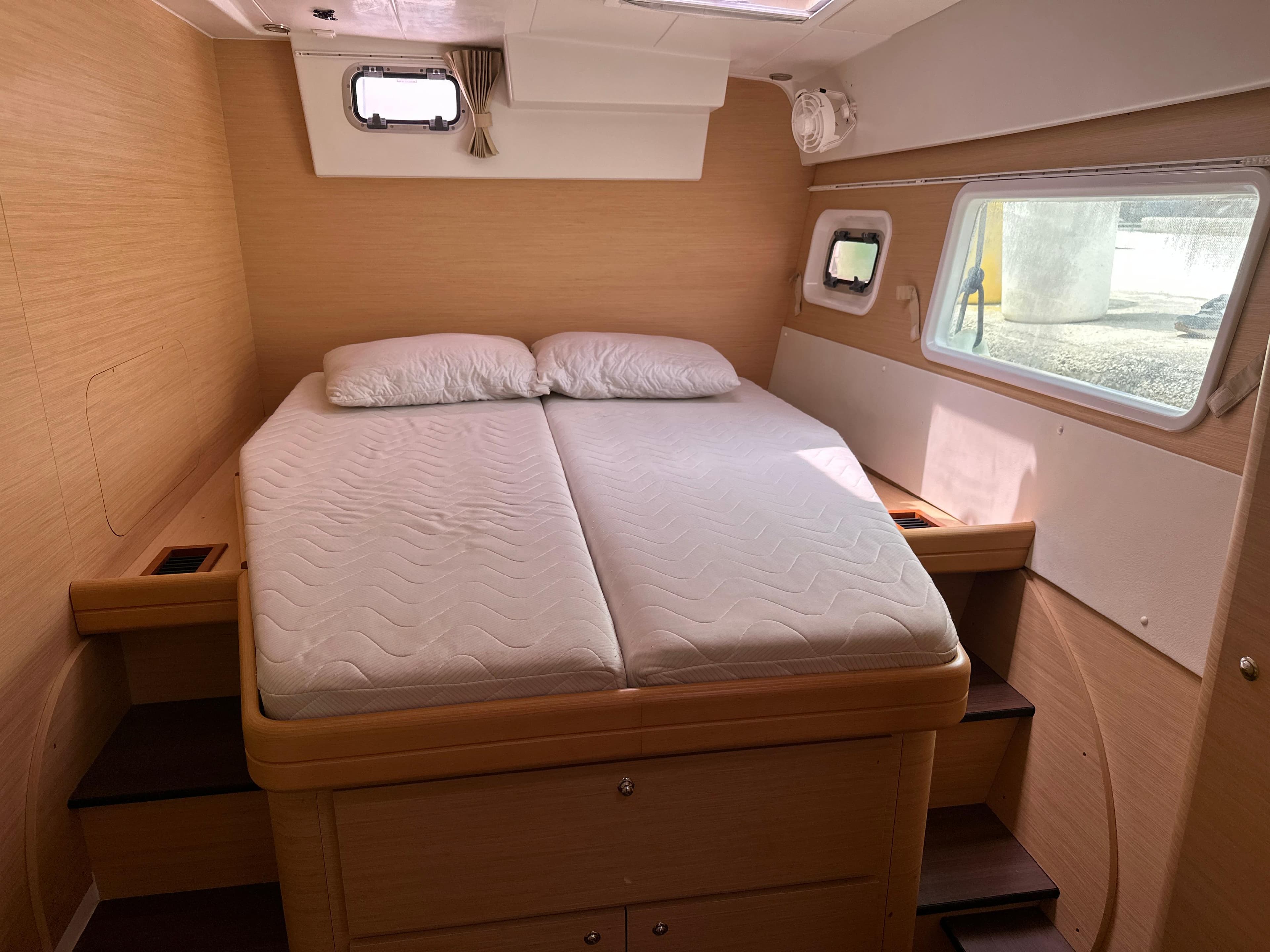 Interior cabin of 2007 Lagoon 421 catamaran with double bed and windows.