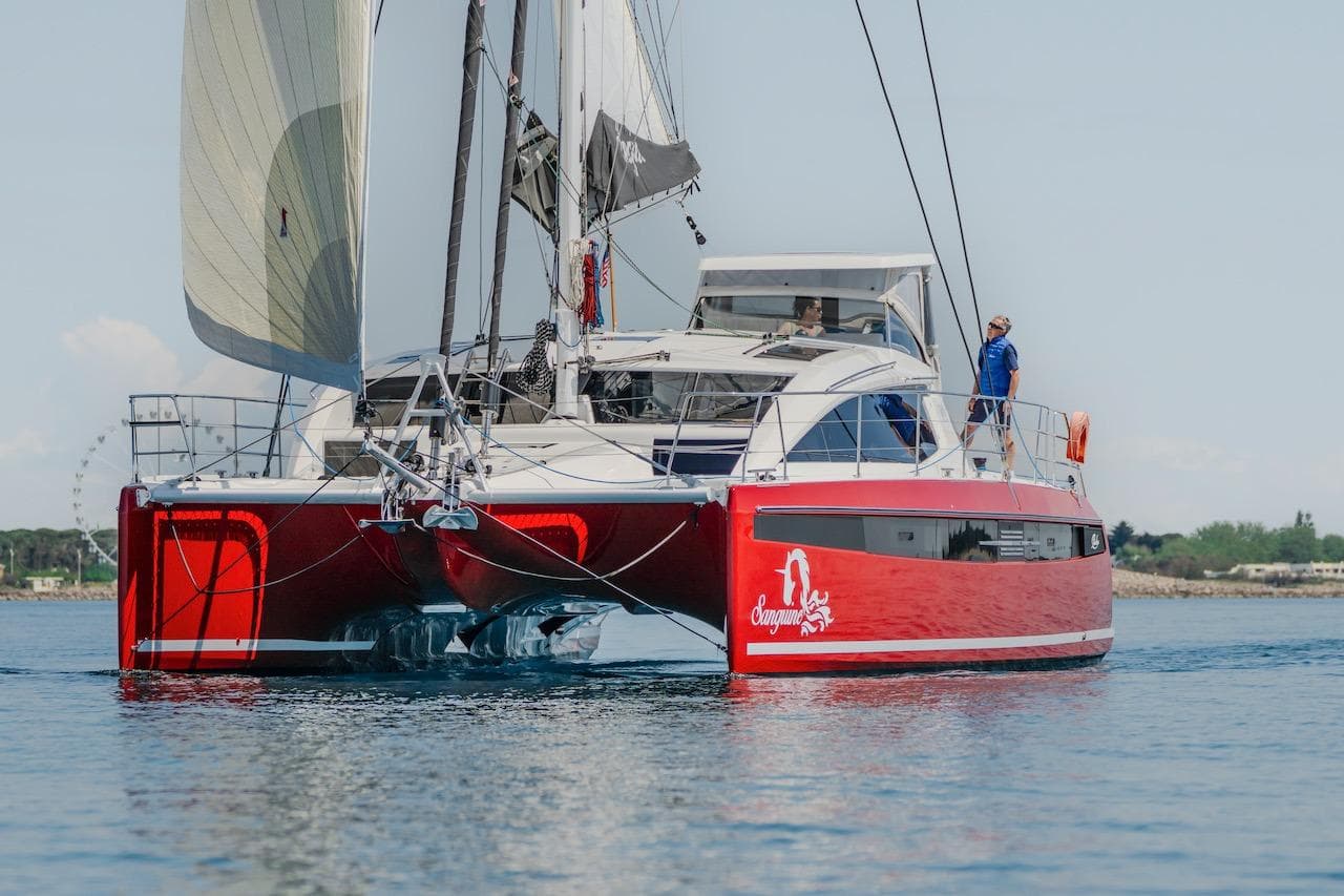 Red Privilege Signature 510 catamaran on calm water, year 2025.