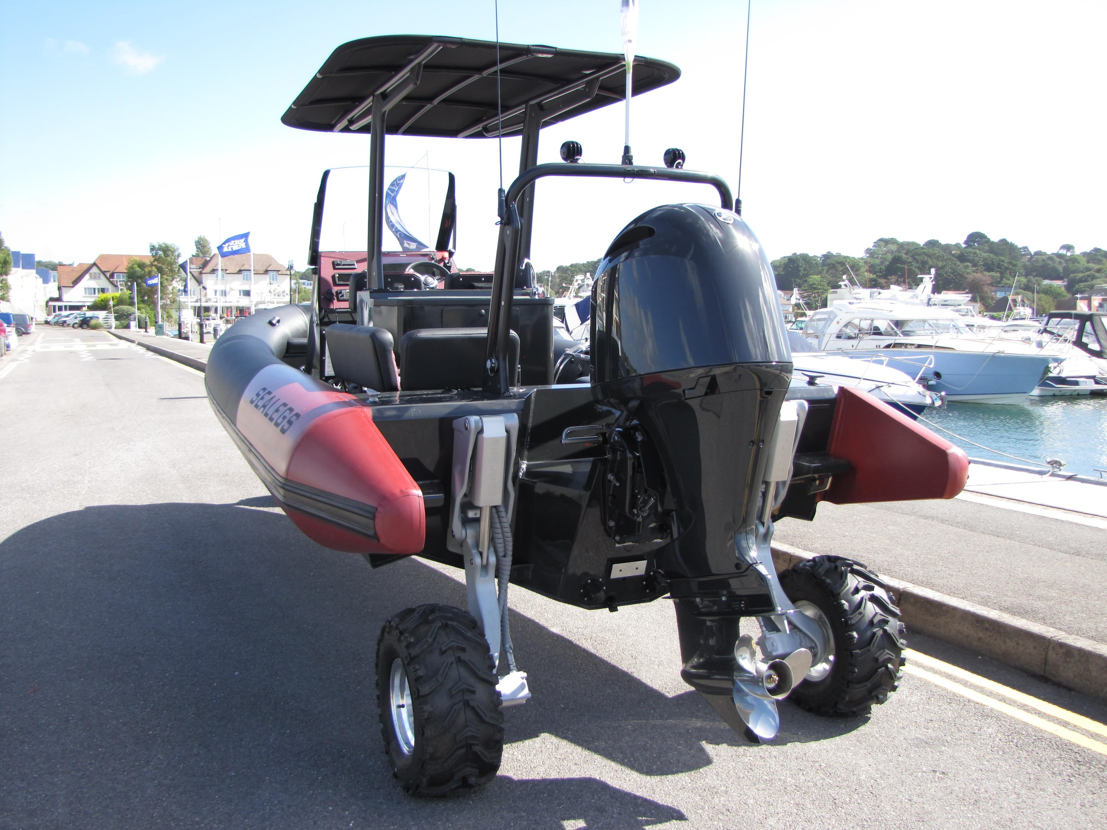 2025 Sealegs 7.5 Hydrasol Amphibious Rib with wheels, docked at a marina.