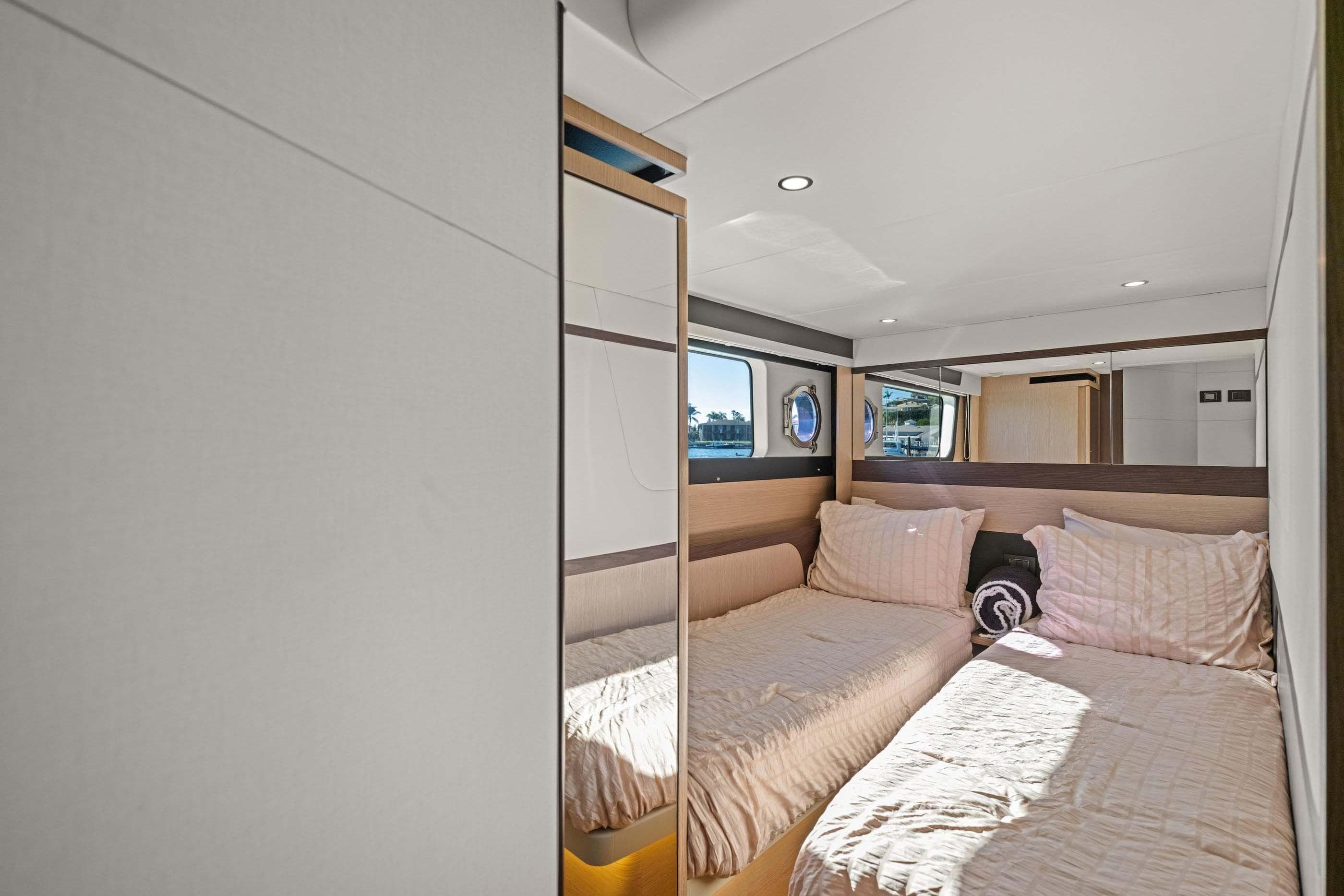 Interior of 2026 Absolute 48 Coupe yacht with twin beds and modern design.