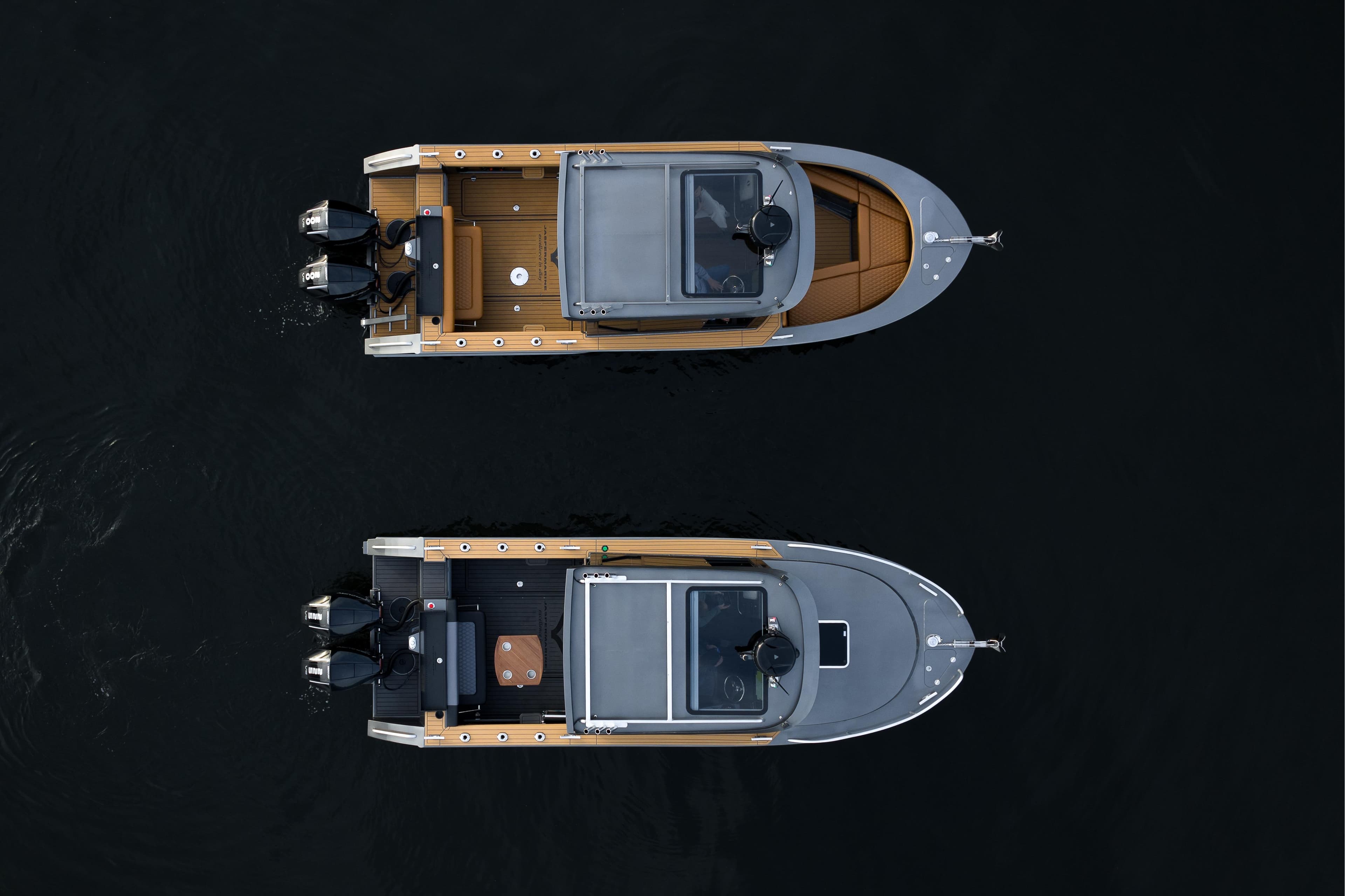 Top view of two 2026 Jasper Marine Defender 22 boats on dark water.