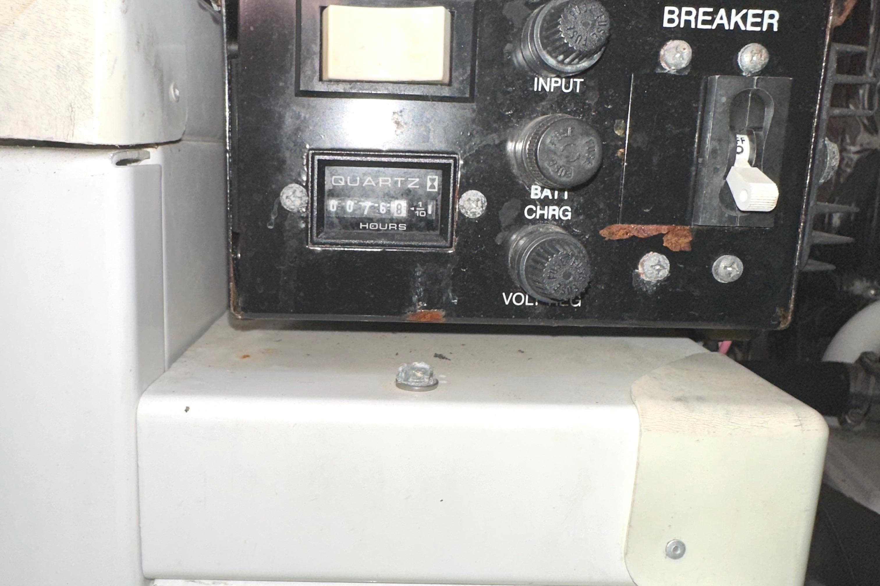 Control panel of a 2006 Larson Cabrio 350 boat with hour meter and breaker switches.